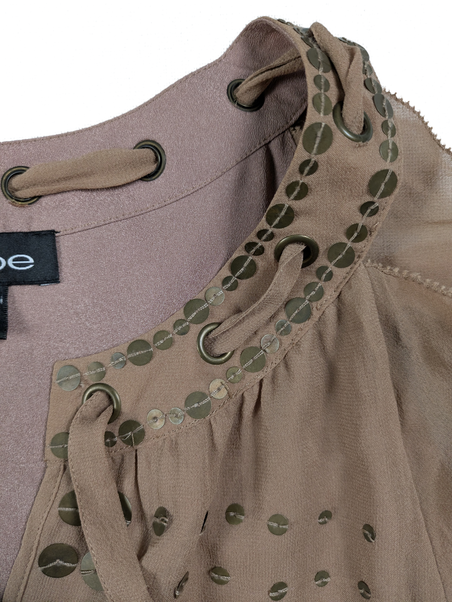Bebe Silk Shell with Brass Sequins and Tie Neck Size Medium Add some fun and whimsy to your wardrobe with the Bebe Silk Shell. This sleeveless tank features a playfu