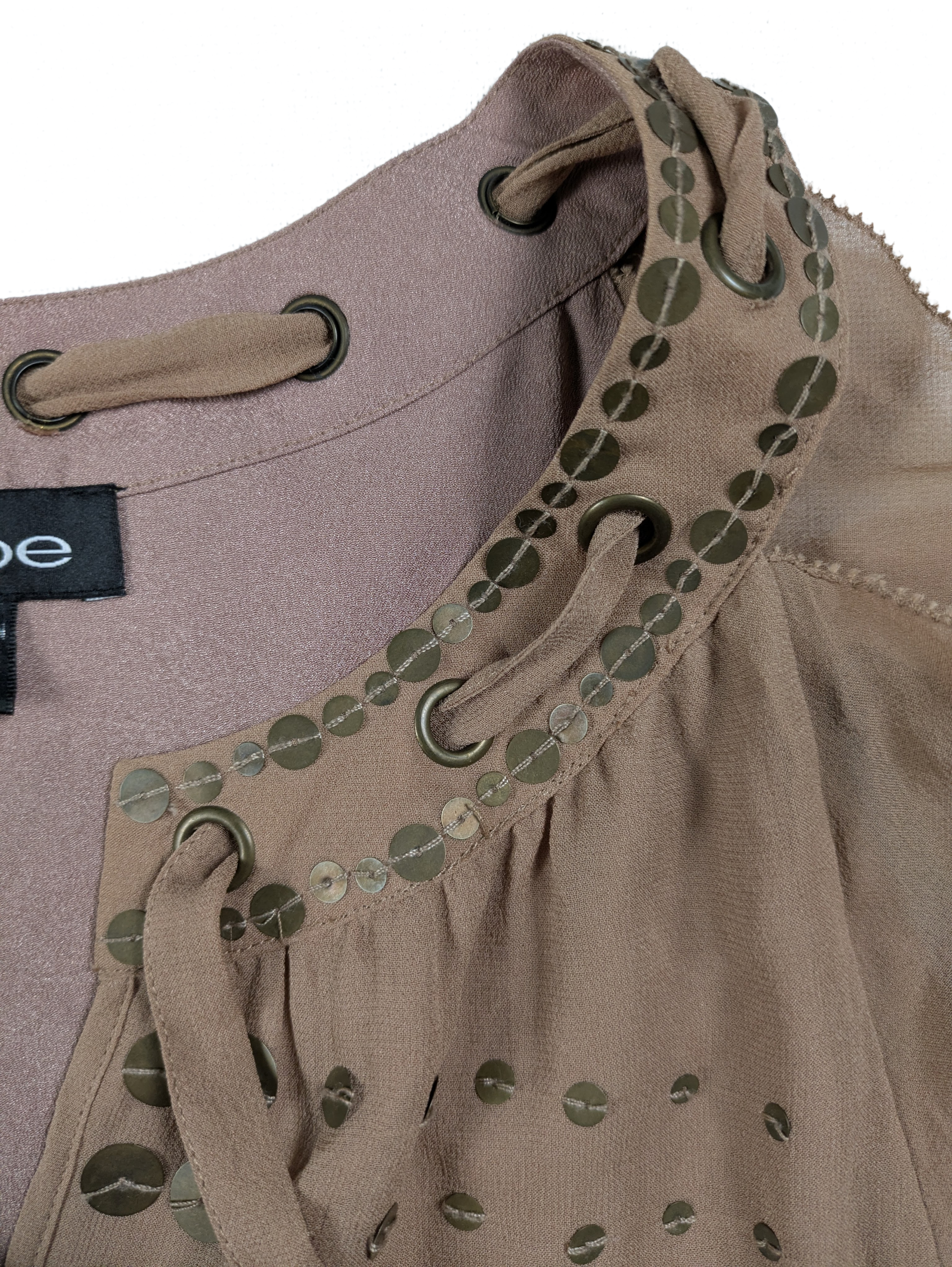 Bebe Silk Shell with Brass Sequins and Tie Neck Size Medium Add some fun and whimsy to your wardrobe with the Bebe Silk Shell. This sleeveless tank features a playfu