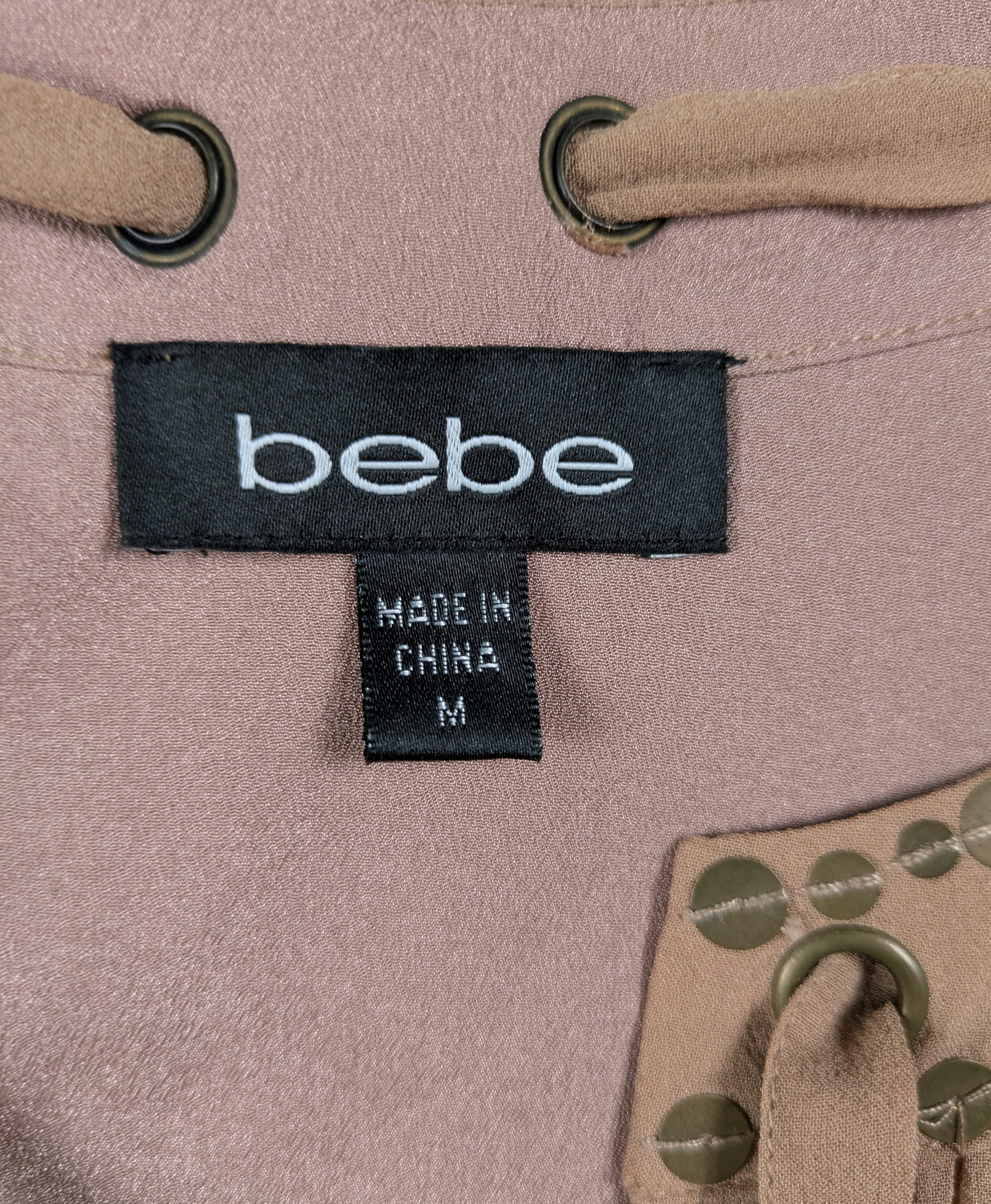 Bebe Silk Shell with Brass Sequins and Tie Neck Size Medium Add some fun and whimsy to your wardrobe with the Bebe Silk Shell. This sleeveless tank features a playfu