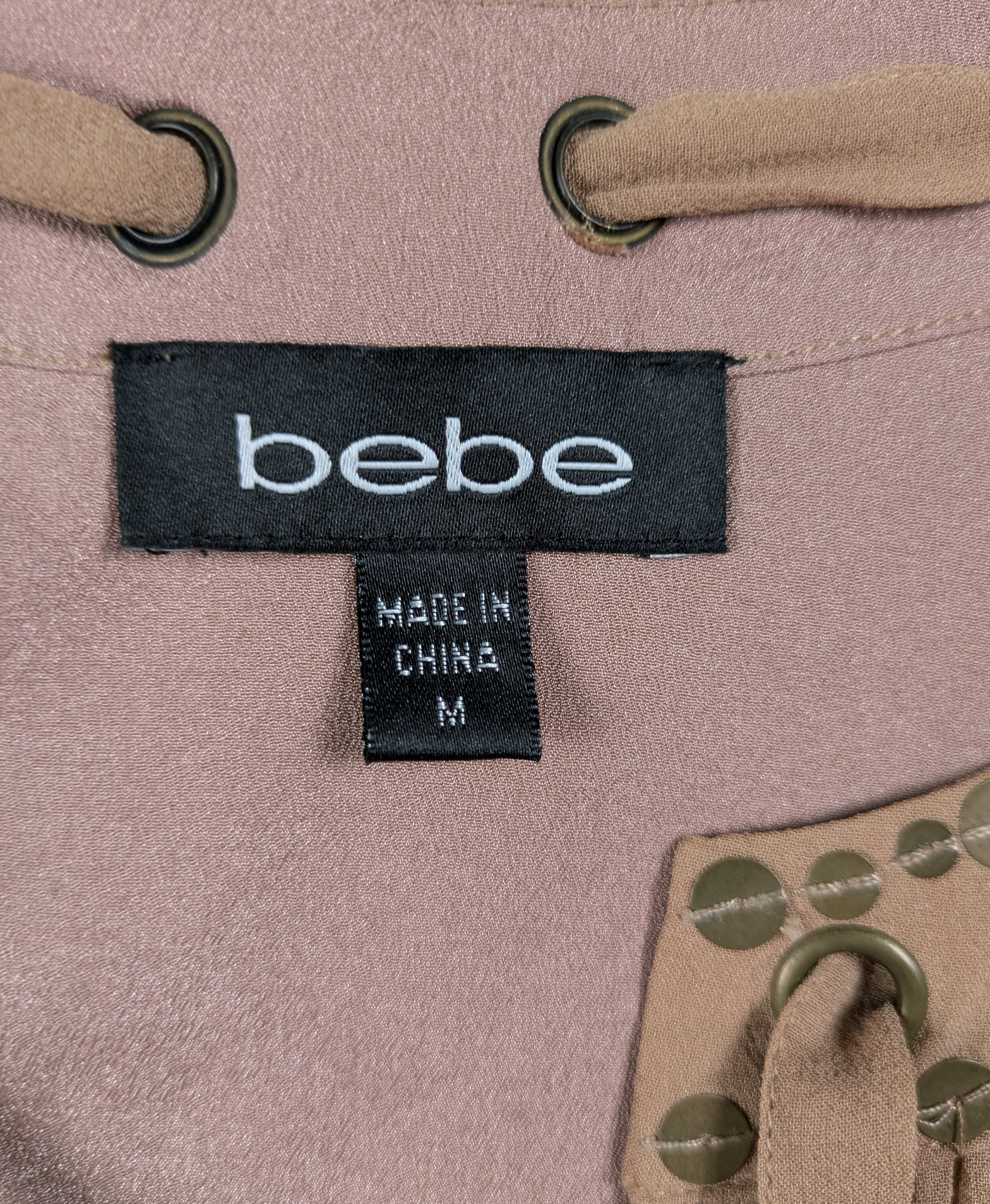 Bebe Silk Shell with Brass Sequins and Tie Neck Size Medium Add some fun and whimsy to your wardrobe with the Bebe Silk Shell. This sleeveless tank features a playfu