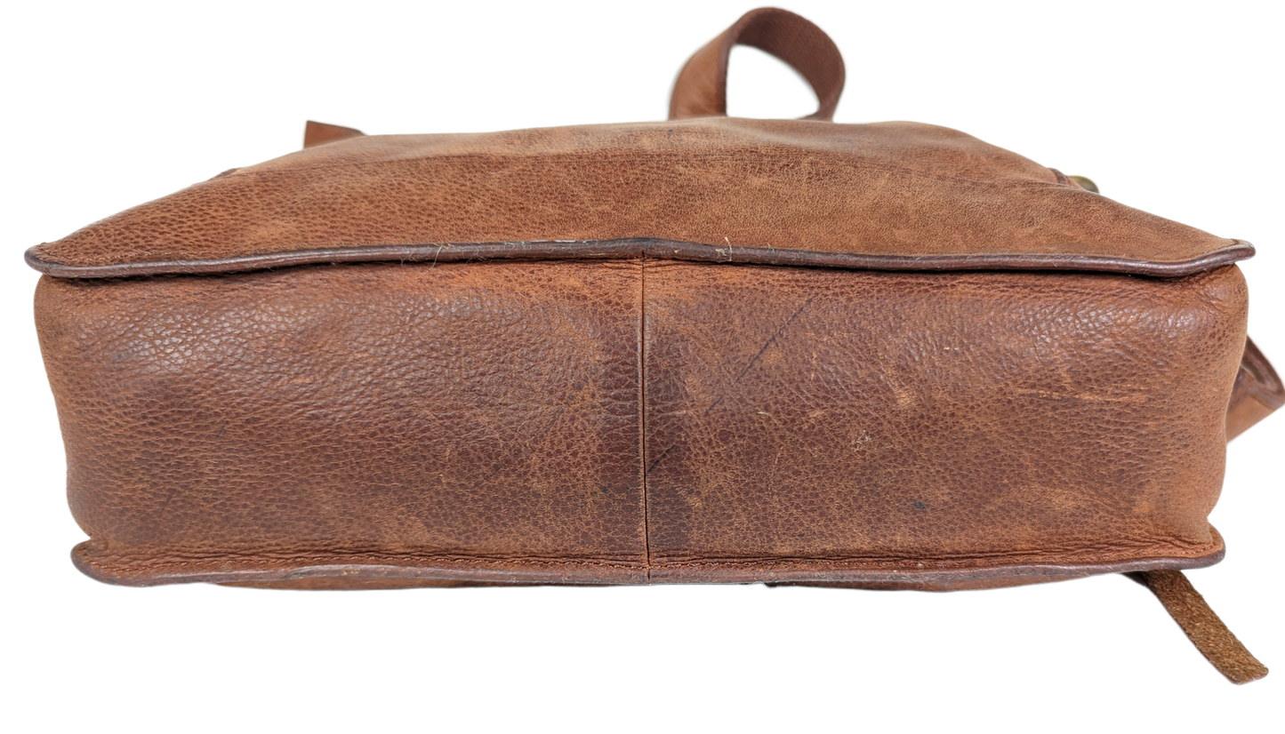 Lucky BrandBeautiful, well-worn leather purse.  Large zip pockets in front and back, and three pockets on inside.  Small pen mark, seen in photo.Purse, handbagLucky Brand Studded Leather PurseLucky Brand Studded Leather Purse