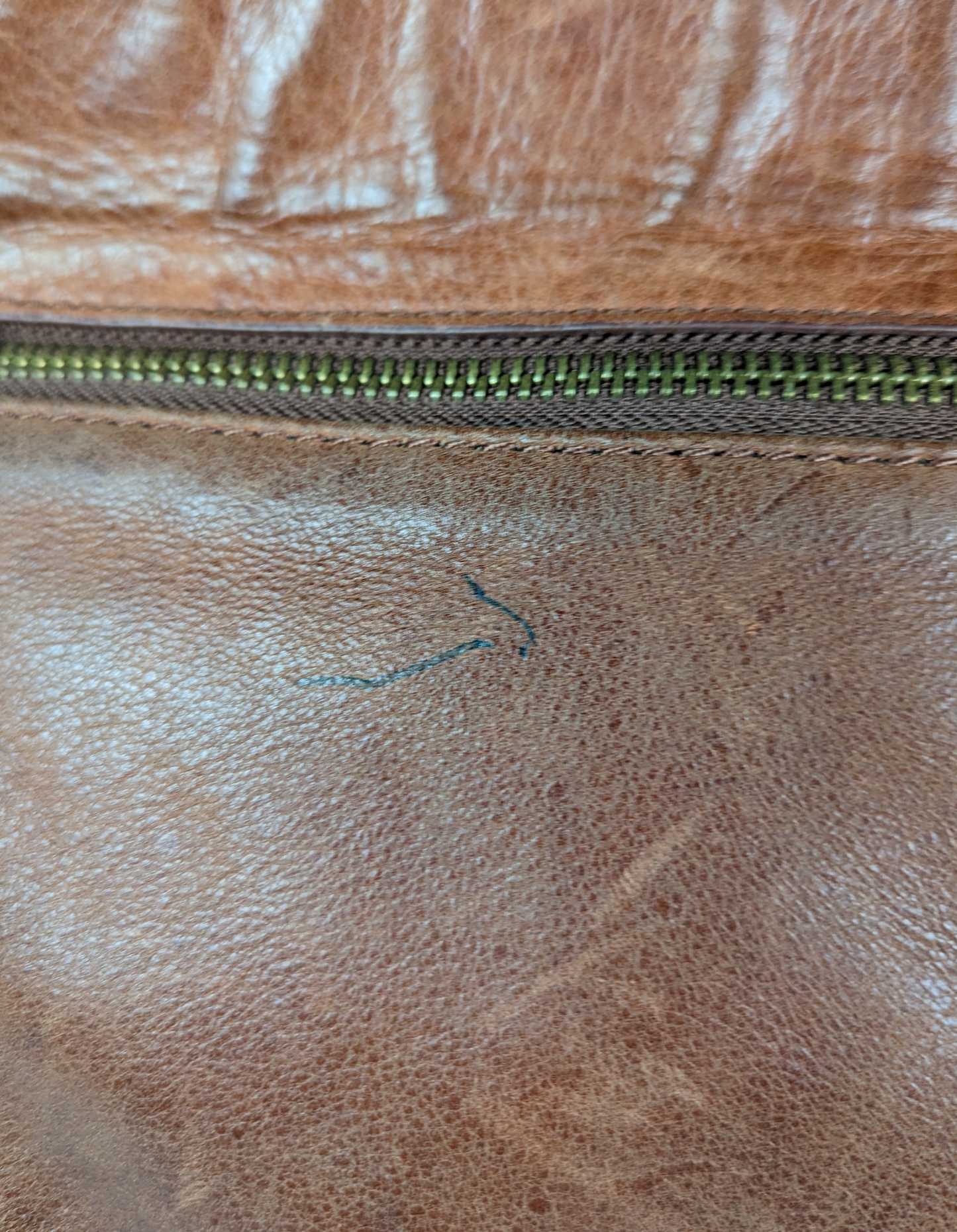 Lucky BrandBeautiful, well-worn leather purse.  Large zip pockets in front and back, and three pockets on inside.  Small pen mark, seen in photo.Purse, handbagLucky Brand Studded Leather PurseLucky Brand Studded Leather Purse