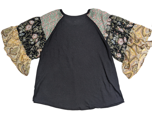 Umgee Black Shirt with Floral Ruffle Sleeves Flower power meets fashion in this Umgee black shirt with floral ruffle sleeves. The soft textured knit and size 1XL make it the perfect blend of comfort and style.