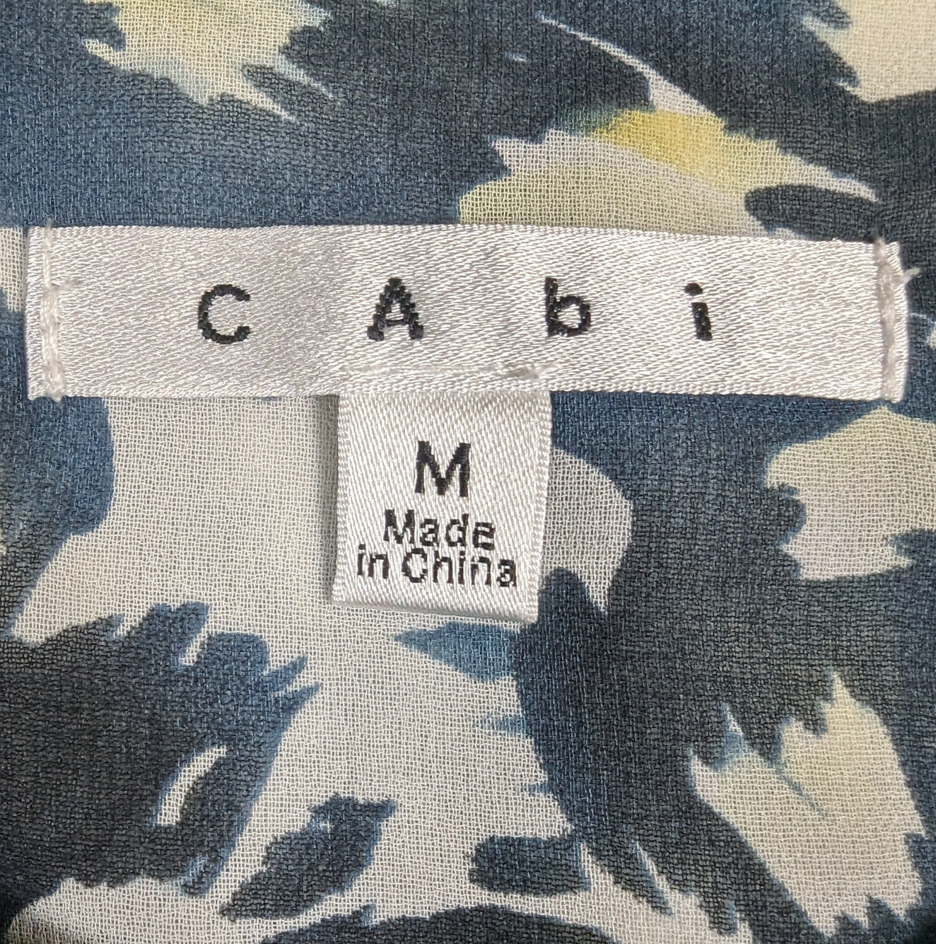 CAbi Avery Blue Sleeveless Tunic Blouse Looking for the perfect summer top? Look no further than our CAbi sleeveless tunic! Made from lightweight, flowy fabric, and featuring a beautiful blue abstract prin