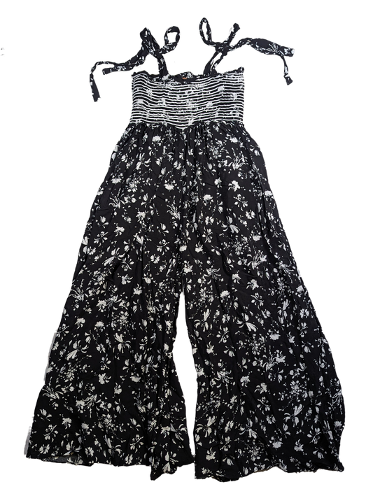 Free People Black and White Smocked Jumpsuit Size XS Go bold and free with the Free People Jumpsuit! This black and white stunner features adjustable shoulder ties a