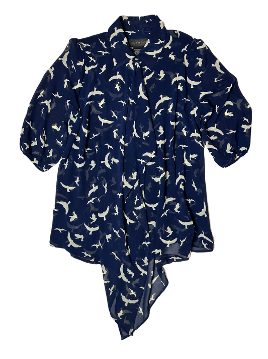 Live a Little Bird Print Blouse with Flowy Front is both stylish and fun. Featuring a unique bird pattern, slightly puffy sleeves, and a flowy front with button closure, this daShirtLive a Little Bird Print Blouse with Flowy FrontBird Print Blouse