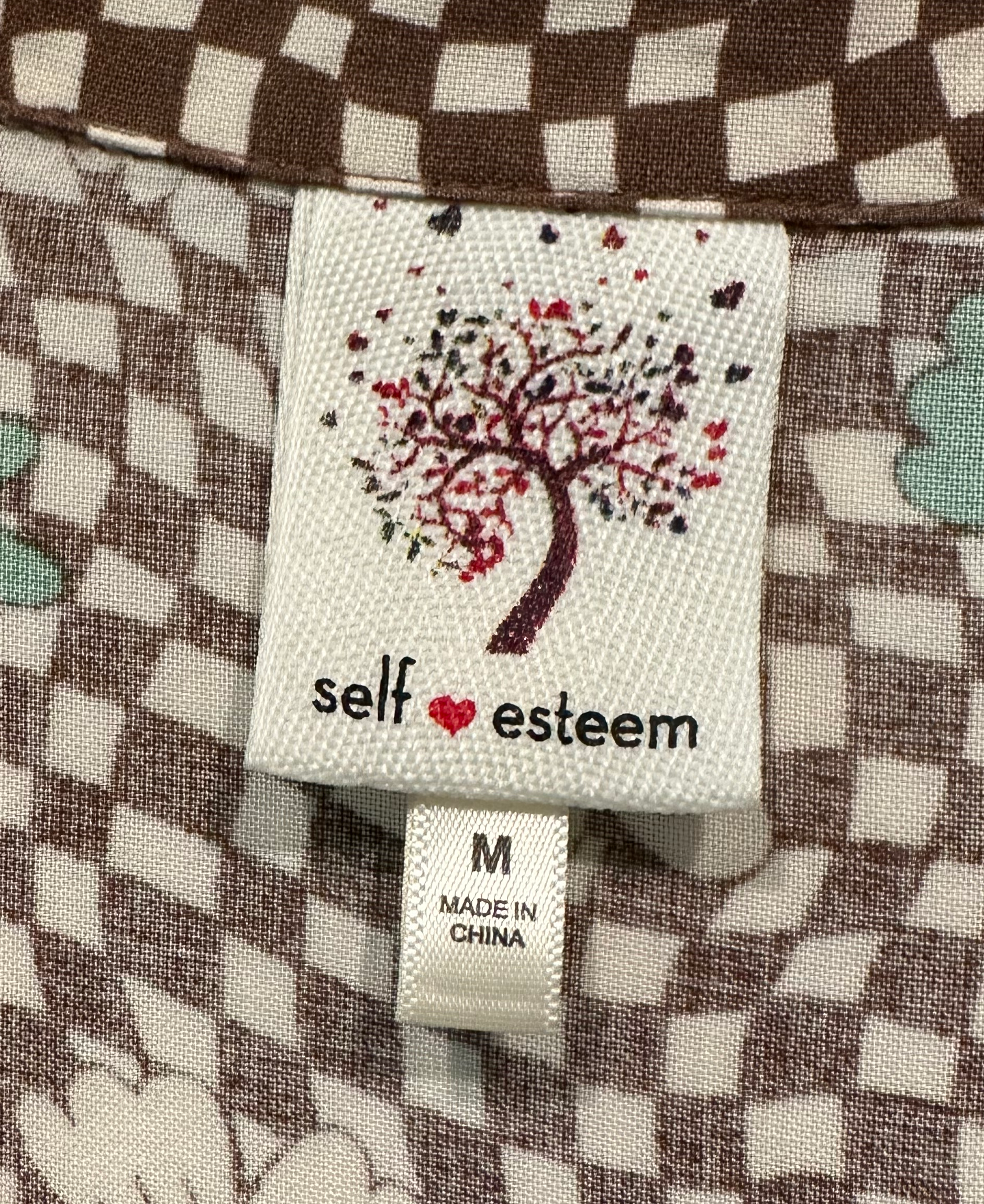 SSelf Esteem Short Sleeve Retro Floral Print Blouse is a vintage wardrobe must-have! With its funky retro floral and checker print in earthy green and brown hues, you'll exude confShirtSelf Esteem Short Sleeve Retro Floral Print BlouseEsteem Short Sleeve Retro Floral Print Blouse