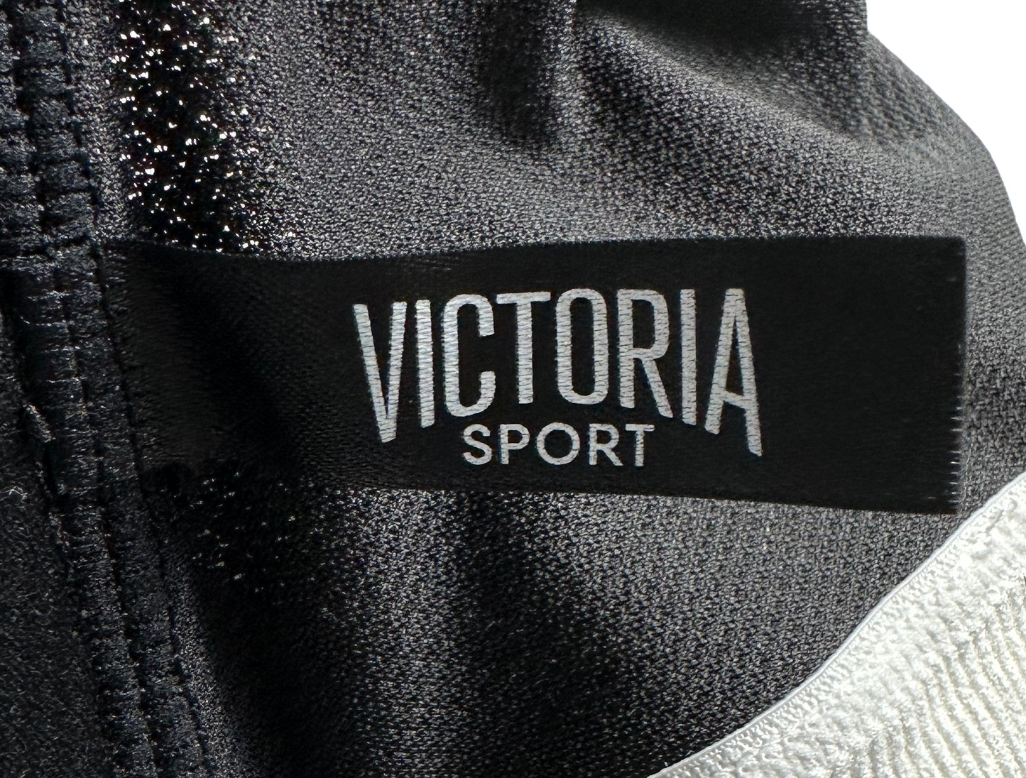 Victoria Secret Sports Bra Black with Silver Straps and band Feel on top of the world while running, jumping, and stretching in this sporty Victoria Secret Sports bra. This black beauty is equipped with removable pads, a zip fSports BraVictoria Secret Sports Bra Black with Silver Straps and bandVictoria Secret Sports Bra Black