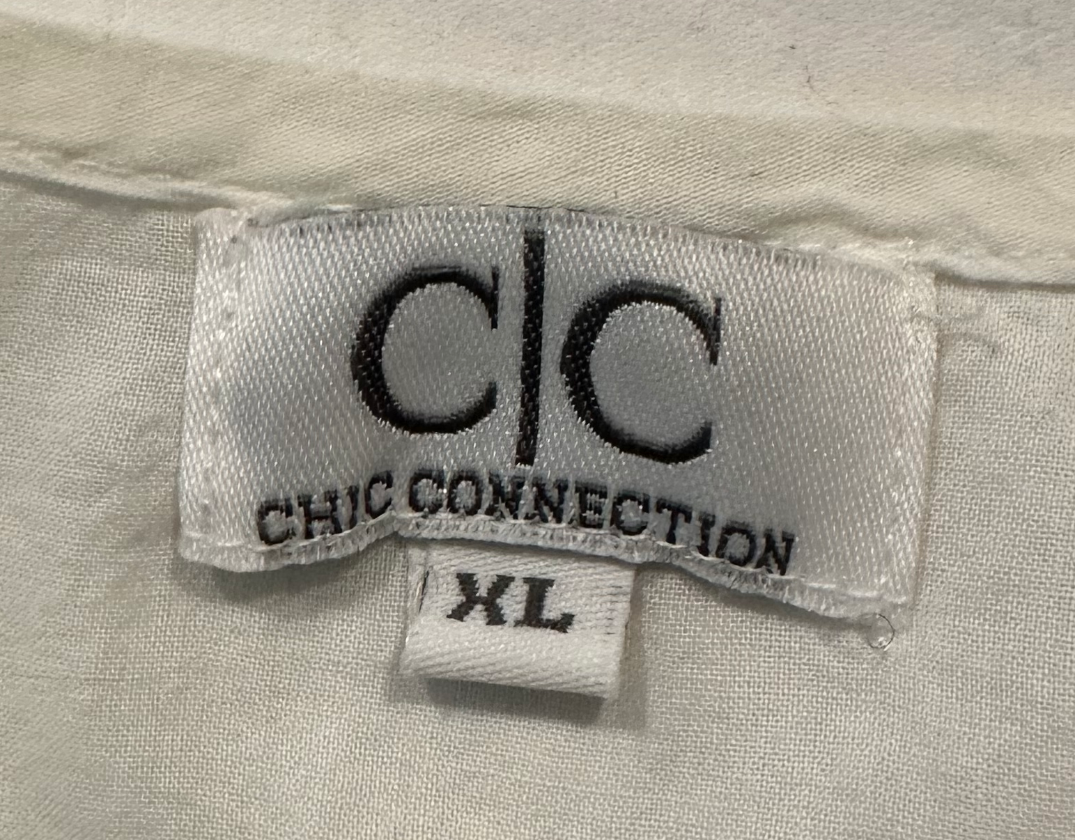 CC Chic Connections White Peasant Blouse with Pink Embroidery Look chic and stylish in this fun, flirty CC Chic Connections white peasant blouse with pink embroidery. Crafted from breathable cotton, its 3/4 sleeves and hot pinkShirtCC Chic Connections White Peasant Blouse with Pink EmbroideryCC Chic Connections White Peasant Blouse