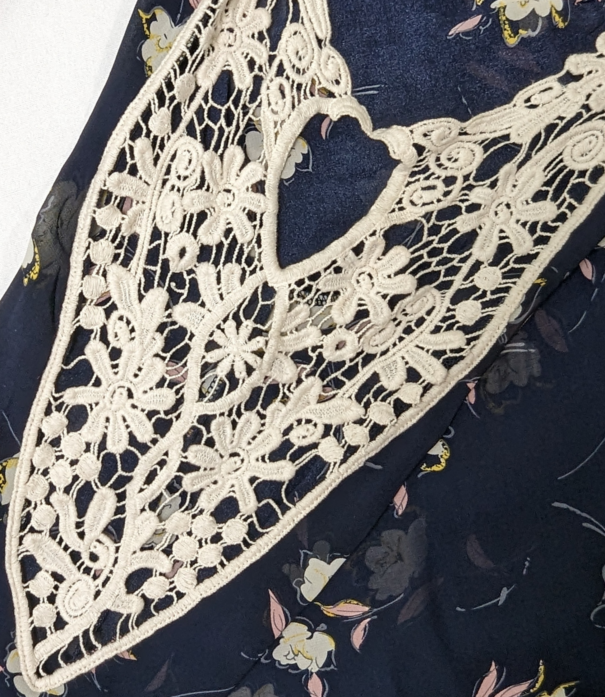 SopranoLive your life in full bloom with this captivating, navy floral blouse. Its cold-shoulder, crochet lace, and sheer fabric give a glam girly feel that's perfect for wShirts & TopsSoprano Cold Shoulder Floral BlouseSoprano Cold Shoulder Floral Blouse