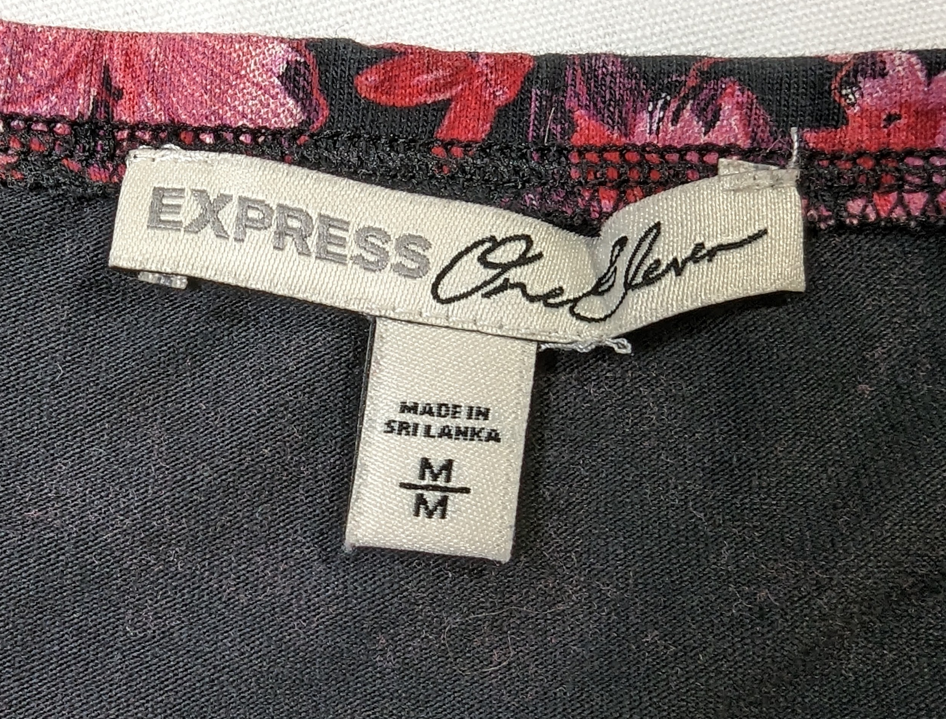 ExpressOur Express One Eleven Floral Bodysuit, made of a Cotton/Spandex blend, features a beautiful floral print on a black background with a 3/4 sleeve, off shoulder styleBodysuitExpress One Eleven Floral BodysuitEleven Floral Bodysuit