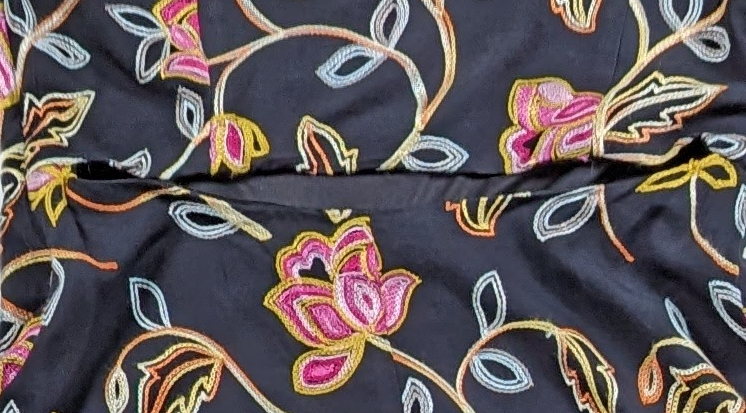 Nicole Miller Black Embroidered High-Low DressLovely embroidered dress from Nicole Miller features a high-low hemline, side-zip and a cut-out back.  Colorful floral embroidery is set against a black background tNicole Miller Black Embroidered High-Low DressDresses