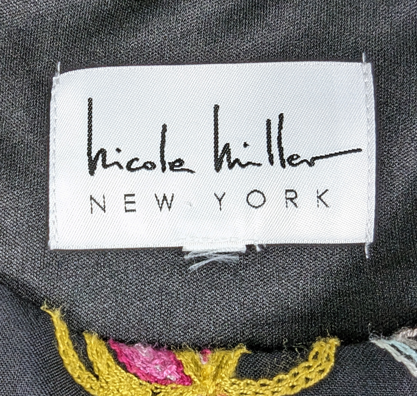 Nicole Miller Black Embroidered High-Low DressLovely embroidered dress from Nicole Miller features a high-low hemline, side-zip and a cut-out back.  Colorful floral embroidery is set against a black background tNicole Miller Black Embroidered High-Low DressDresses