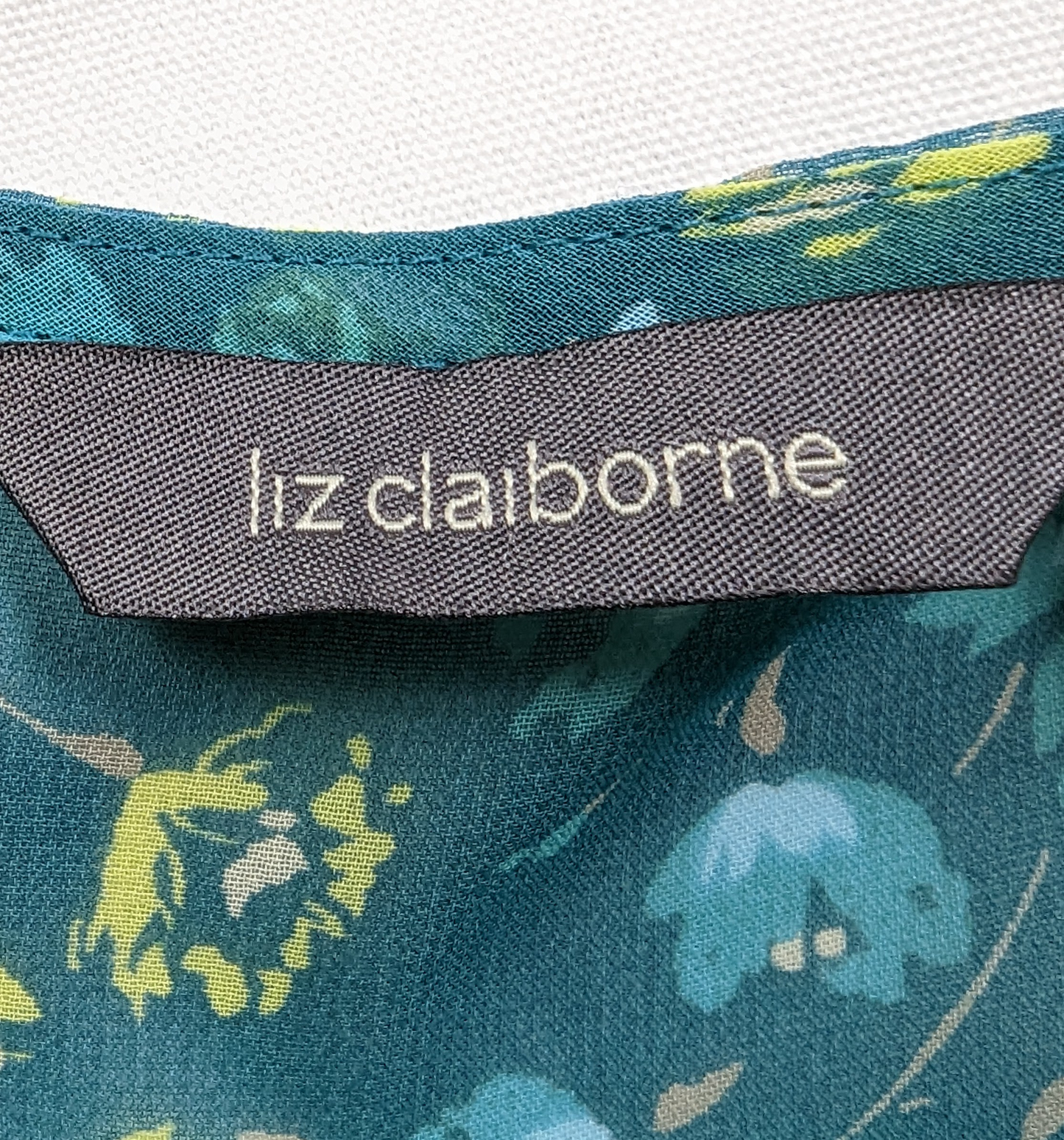 Liz Claiborne Empire-Waist Flutter-sleeve Blouse with ribbon detailsLiz Claiborne Empire-Waist, Flutter-sleeve Blouse with ribbon details. This Liz Claiborne Blouse features a stylish flutter sleeve design, an empire waist, and a lig