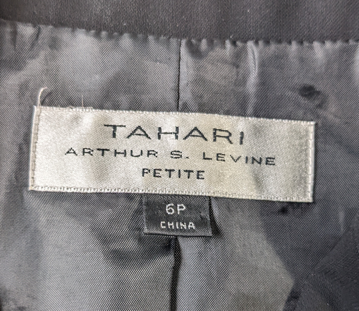 Tahari Arthur S Levine Black Blazer Size 6P  Elevate your professional style with the Tahari Arthur S Levine Black Blazer. This fitted blazer, in a sleek black color