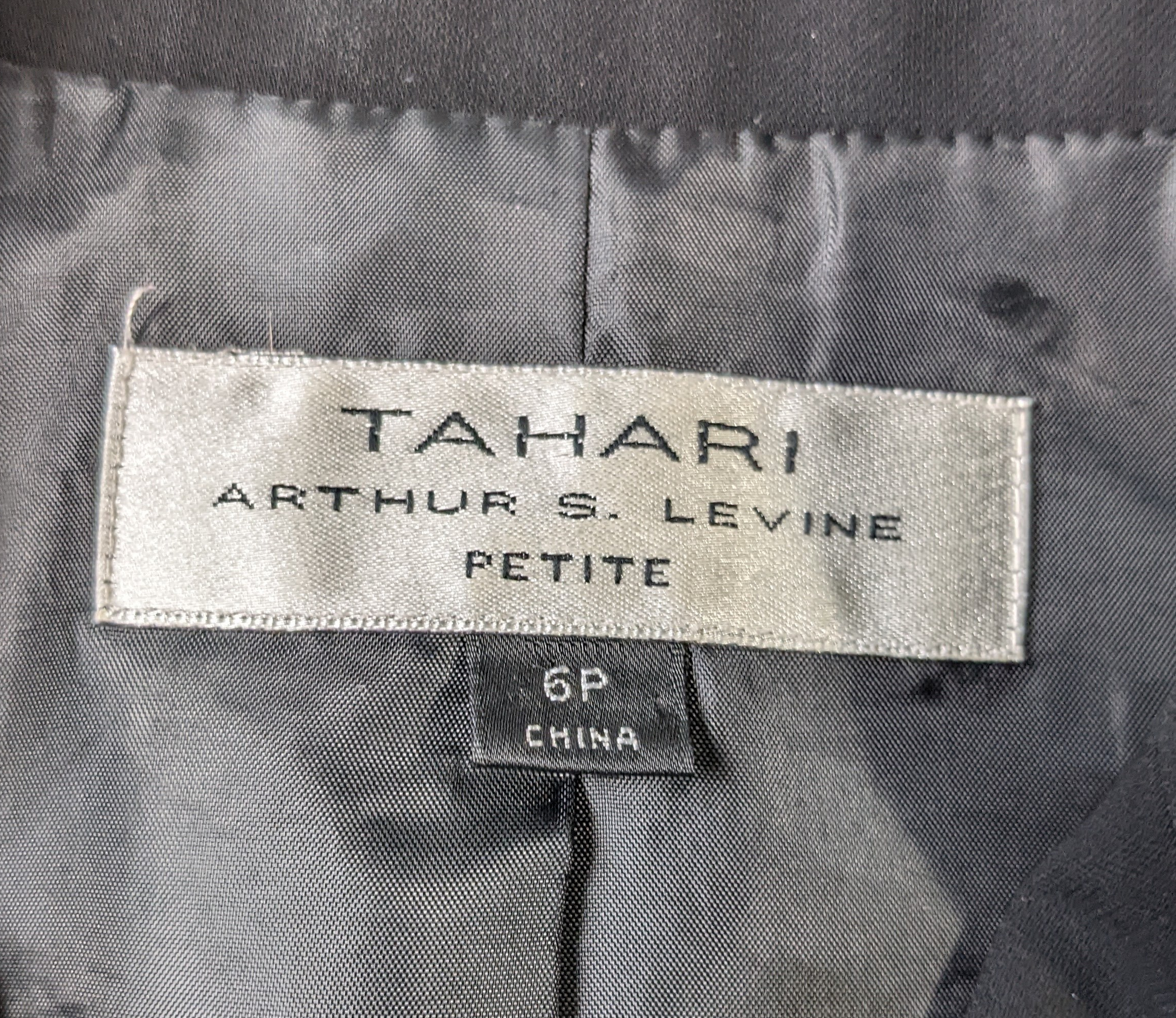 Tahari Arthur S Levine Black Blazer Size 6P  Elevate your professional style with the Tahari Arthur S Levine Black Blazer. This fitted blazer, in a sleek black color