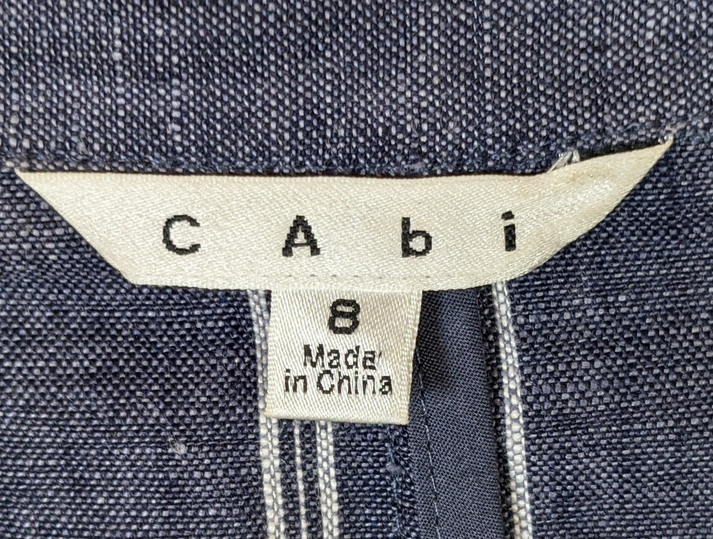 CAbi Linen Pinstripe JacketThis Jacket looks sharp with chevron styled pockets and white pinstripes on the blue linen. The 3/4 sleeves give the blazer a relaxed look.