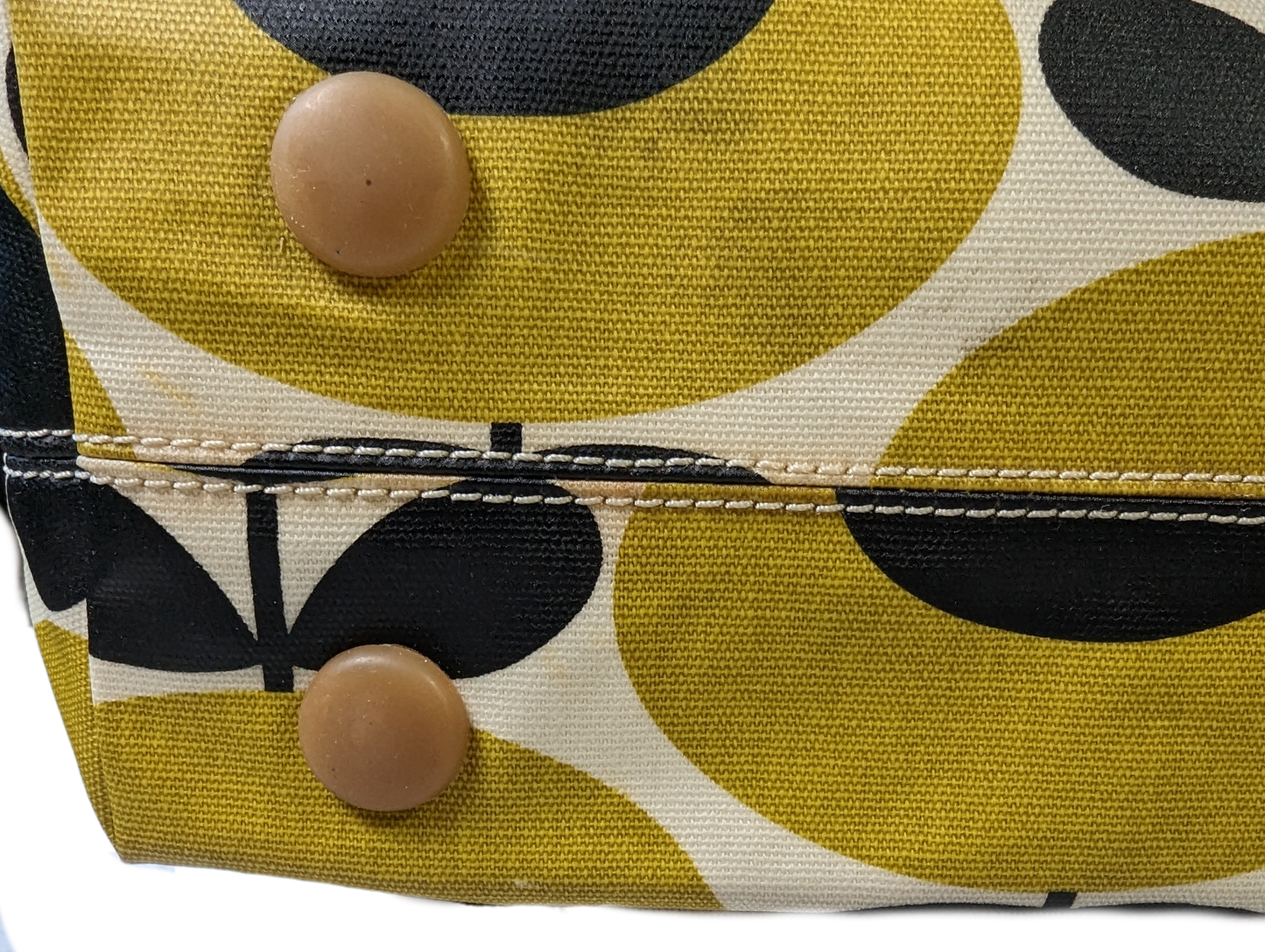 Orla Kiely Rare Mustard Forget-Me-Not Shoulder BagThis bag has such style. It is coated canvas and in excellent condition.  There is some discoloration along the top edge, and on the bottom seam that is detailed in Orla Kiely Rare Mustard Forget-Handbag