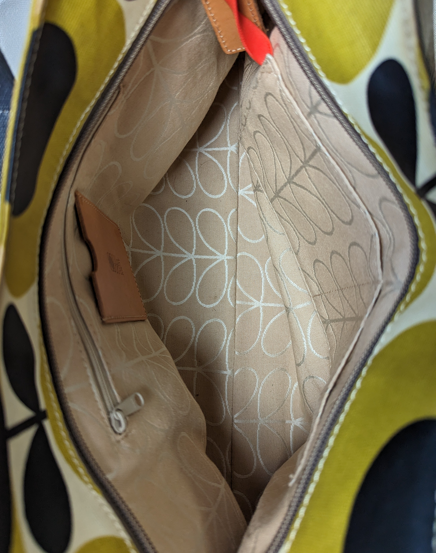 Orla Kiely Rare Mustard Forget-Me-Not Shoulder BagThis bag has such style. It is coated canvas and in excellent condition.  There is some discoloration along the top edge, and on the bottom seam that is detailed in Orla Kiely Rare Mustard Forget-Handbag
