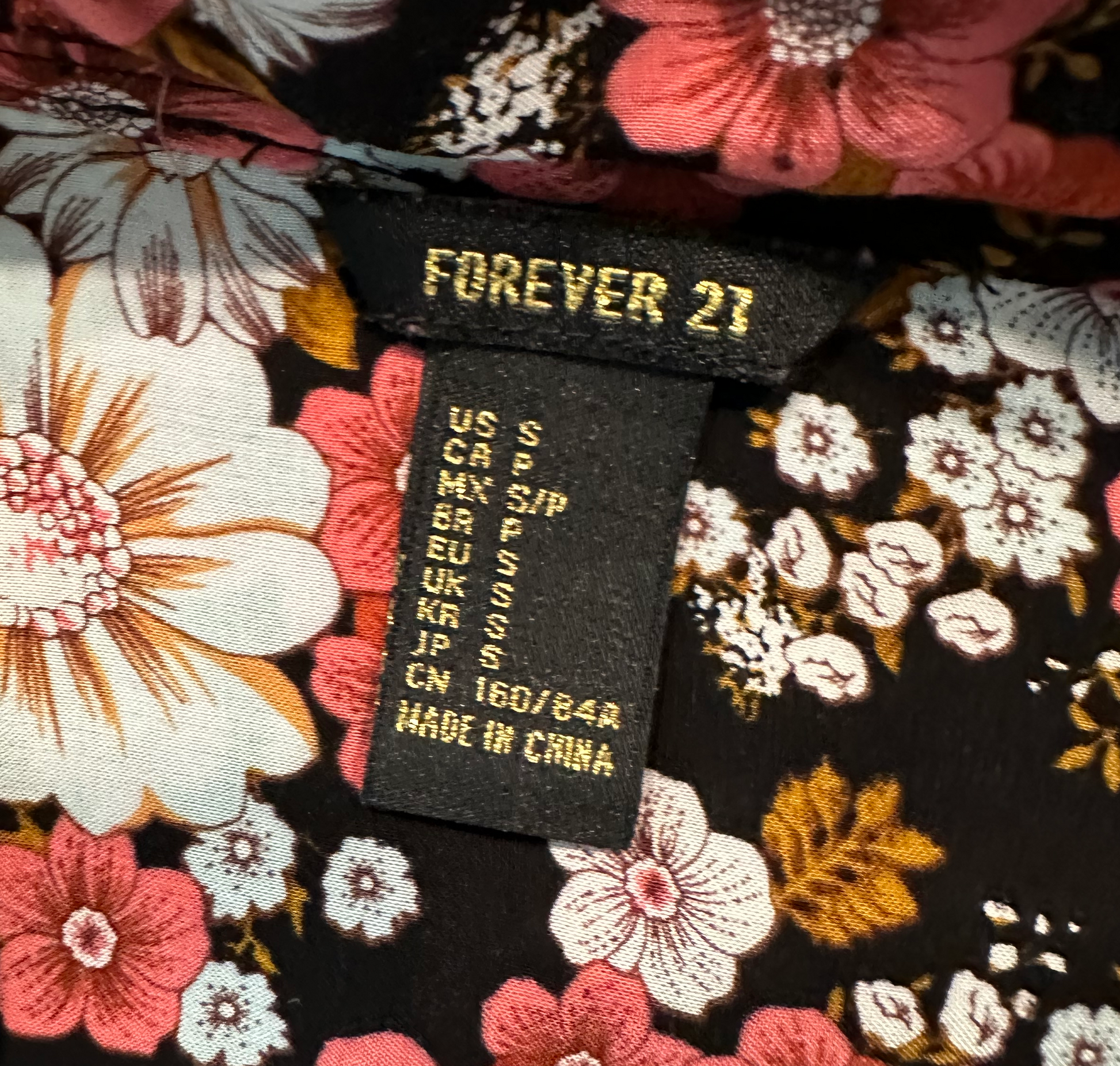 Forever 21 Black Floral Long Tunic with Tie at NeckWear this pretty floral tunic with leggings and sandals for a brunch date, or toss on heels for a night at the movies.Forever 21 Black Floral Long TunicShirt