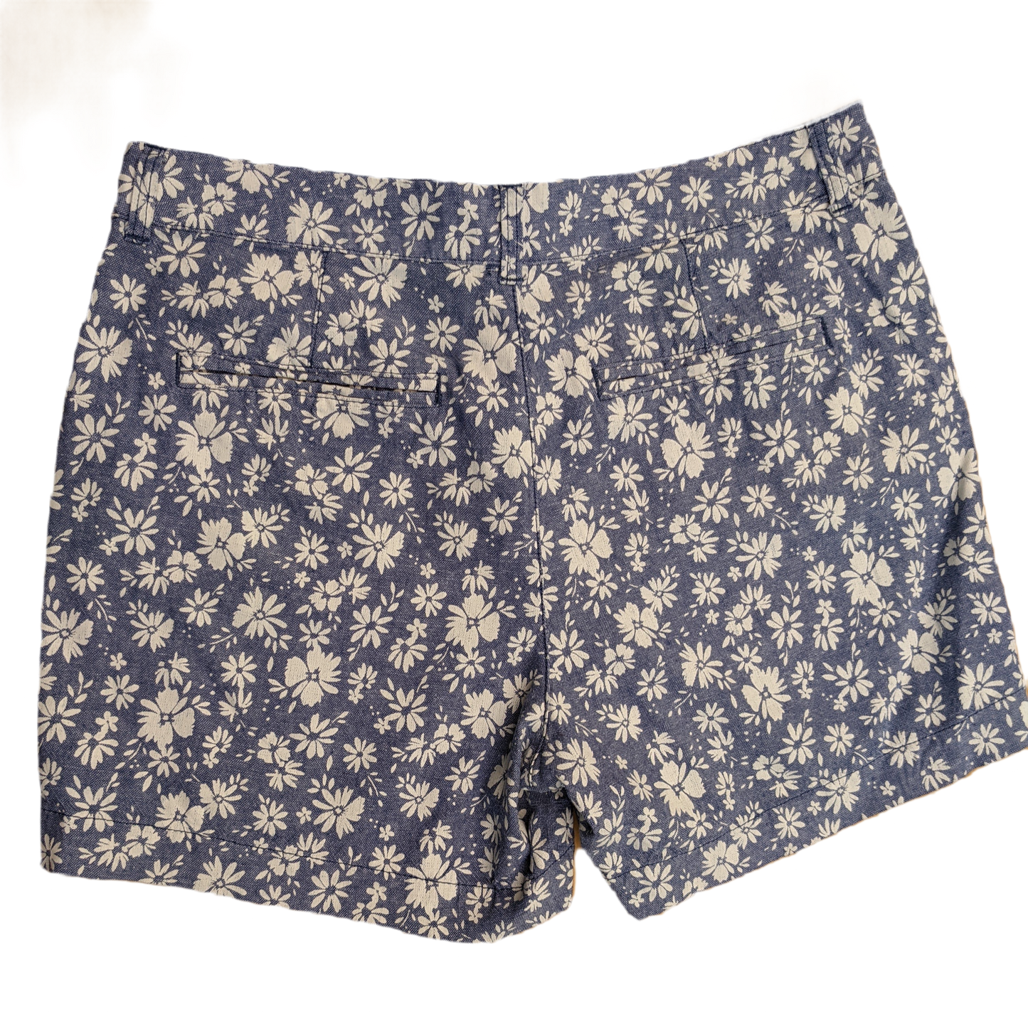 Old Navy High Rise Floral Print Shorts Old Navy high rise blue shorts with white floral print. Zip front with pockets in the front and back.