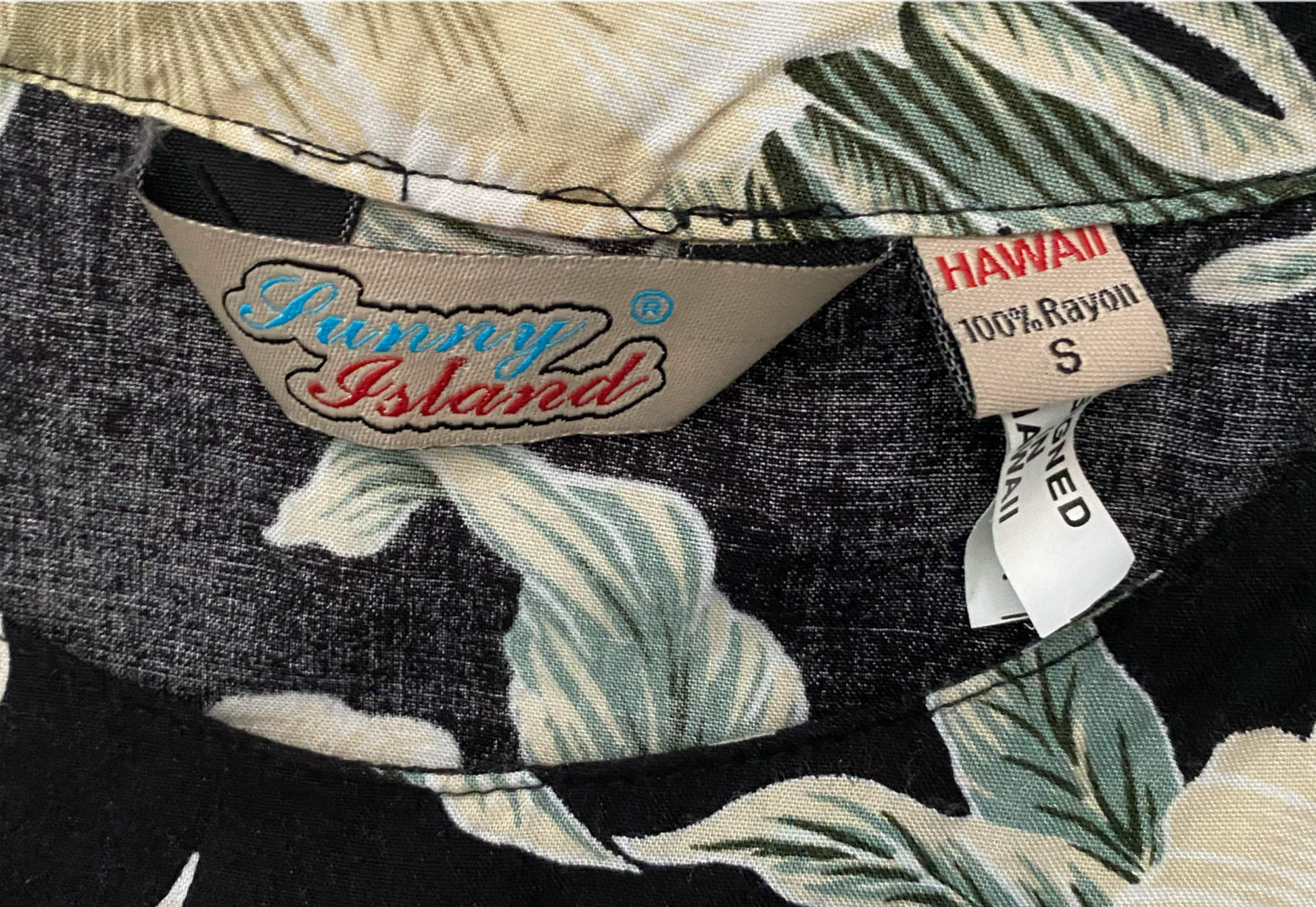 Sunny Islands Floral Print Shirt Sunny Islands black with floral print sleeveless shirt.
