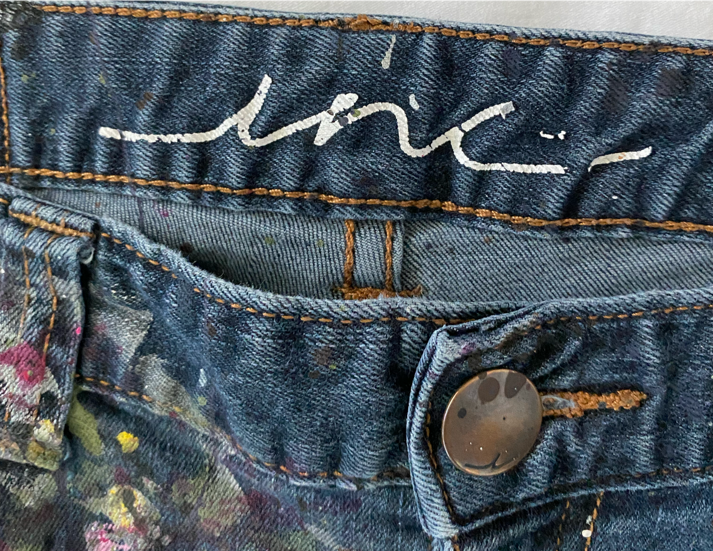 REFRESHED - INC Hand Painted Dark Denim Jeans Size 12 Get ready to make a statement with these REFRESHED dark denim jeans from INC. Featuring a slight flare leg and