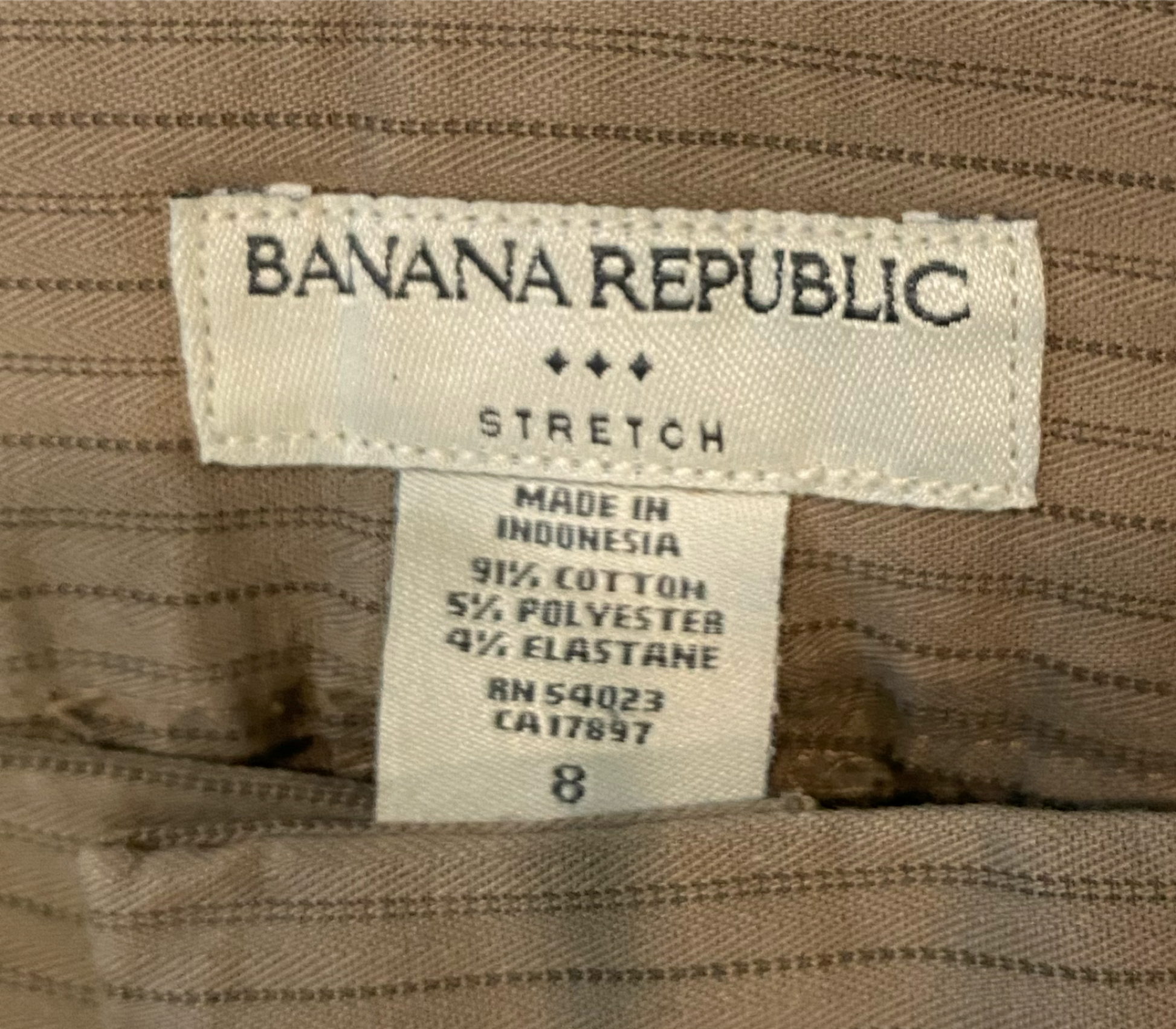 Banana Republic Tan Striped Pant Tan pant with thin brown stripes. Slit front and back pockets, wide leg and cuffed hem.