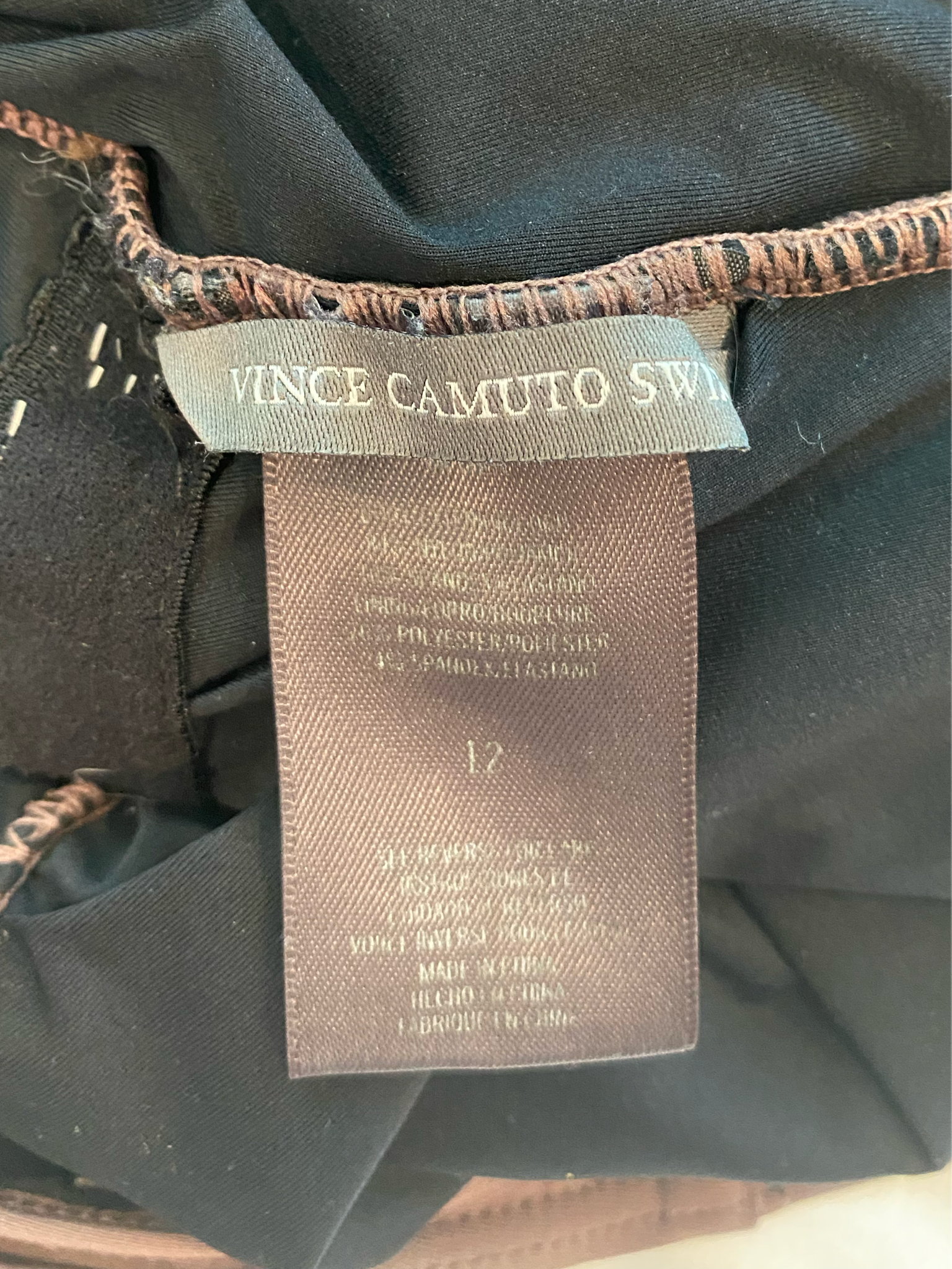 Vince Camuto Plum Colored One Piece Swim Suit Dive into playful elegance with the Vince Camuto One Piece Swim Suit. This unique plum colored suit features a deep V n
