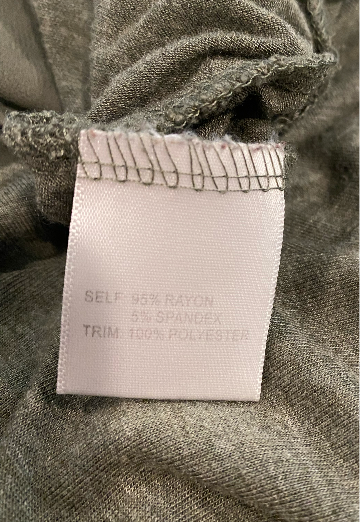 Rose + Olive Three Quarter Sleeve Top with Chain Detail at Neckline Olive green top with a delicate sheer trim at bottom of hem and grey chain at the neckline. Delic