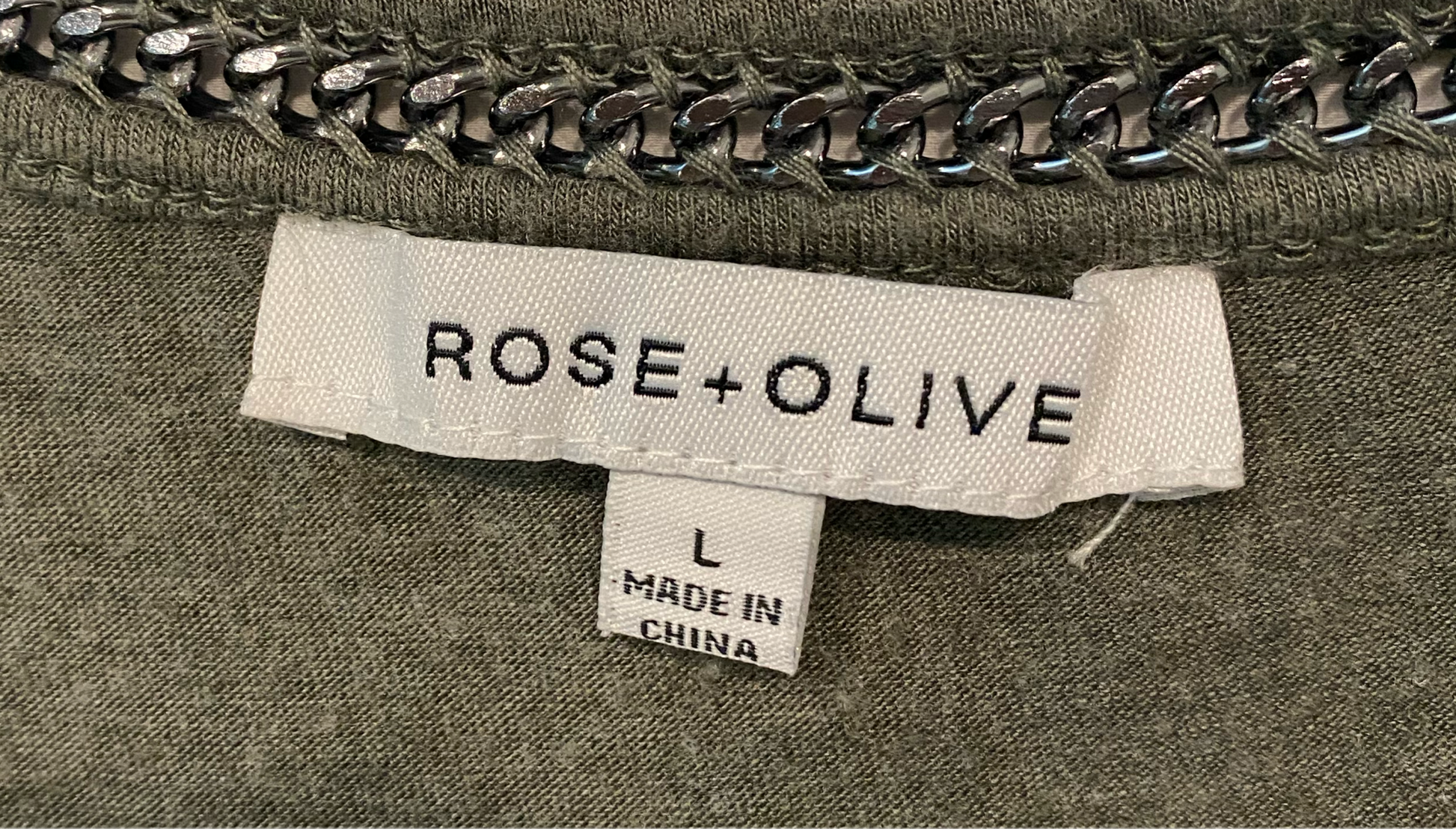 Rose + Olive Three Quarter Sleeve Top with Chain Detail at Neckline Olive green top with a delicate sheer trim at bottom of hem and grey chain at the neckline. Delic