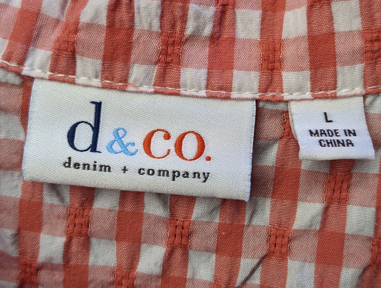 d & Co Orange Gingham Blouse with Ruffled Hem and CuffsSuch a cute and flirty blouse, with ruffle details at the hem and cuffs. And the orange gingham is perfect for a day out!