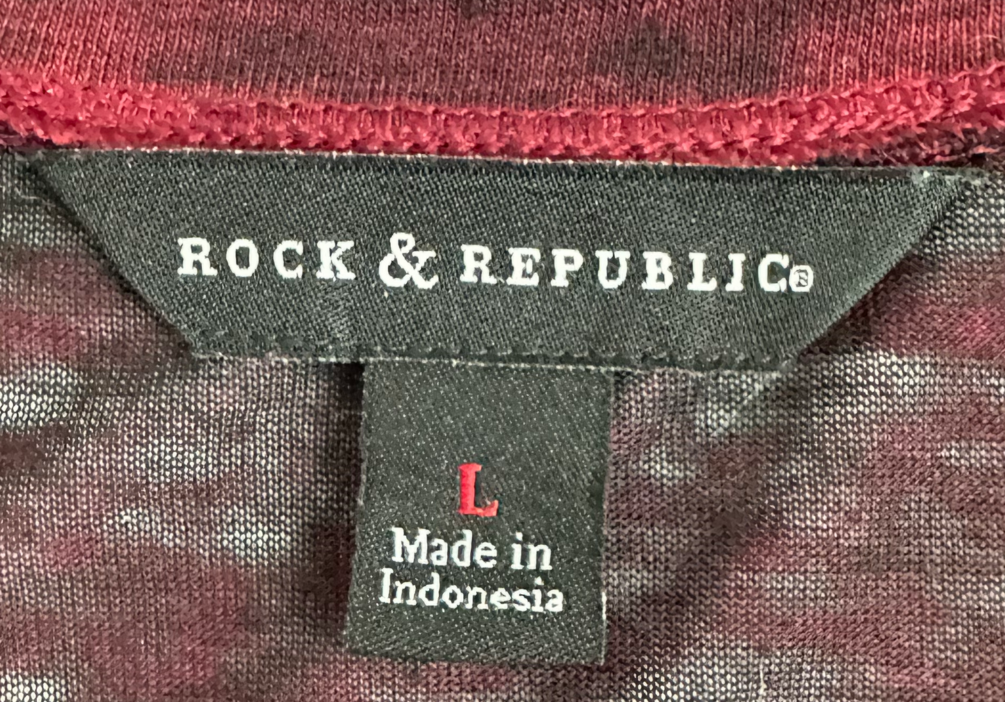 Rock & Republic Red with Black Wash V-neck Tissue TeeRock & Republic's red with black wash tissue tee is a stylish addition to any wardrobe. Cut from a lightweight, sheer tissue-like fabric, this short-sleeved tee