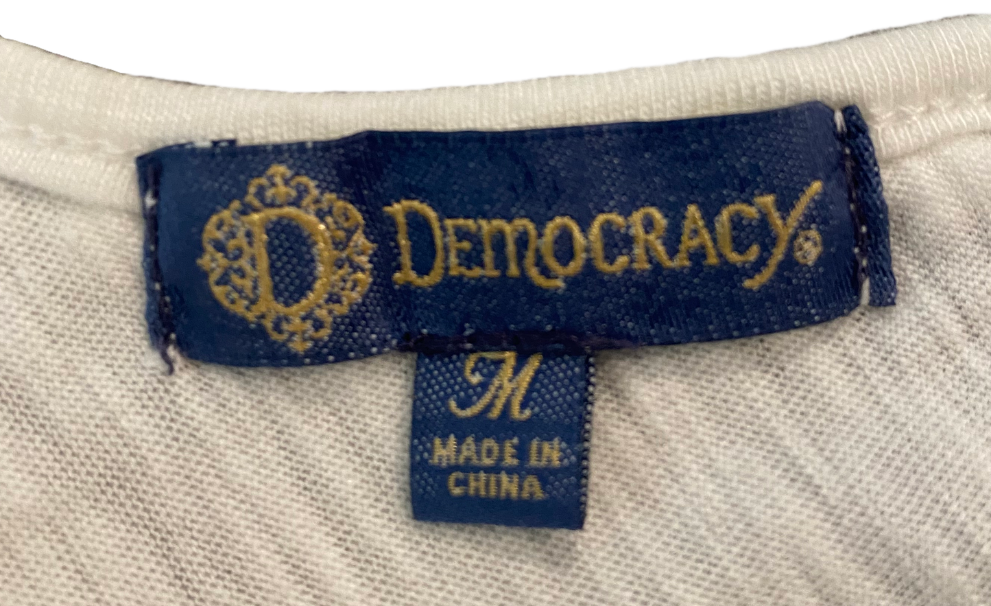 Democracy White V-Neck Cap Sleeve Top The perfect little white top! V neck in the front and back with a tie across the back. Thoughtful details make this the iconic top for Summer!!