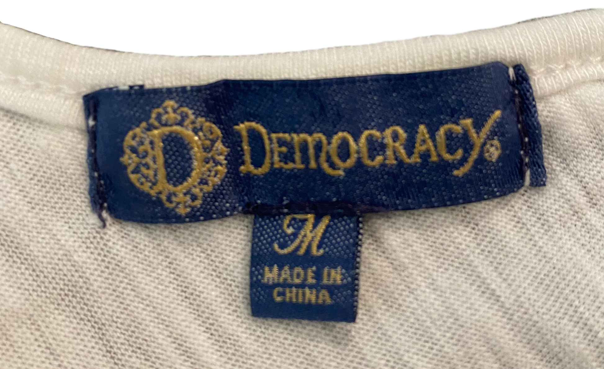Democracy White V-Neck Cap Sleeve Top The perfect little white top! V neck in the front and back with a tie across the back. Thoughtful details make this the iconic top for Summer!!