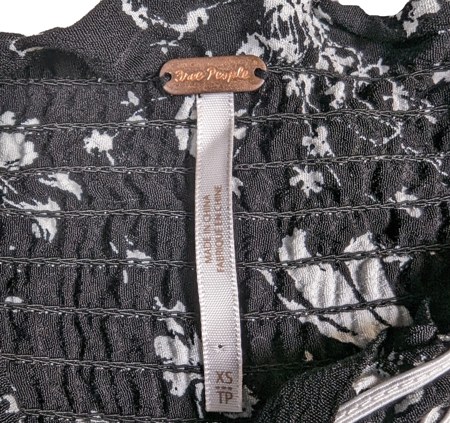 Free People Black and White Smocked Jumpsuit Size XS Go bold and free with the Free People Jumpsuit! This black and white stunner features adjustable shoulder ties a