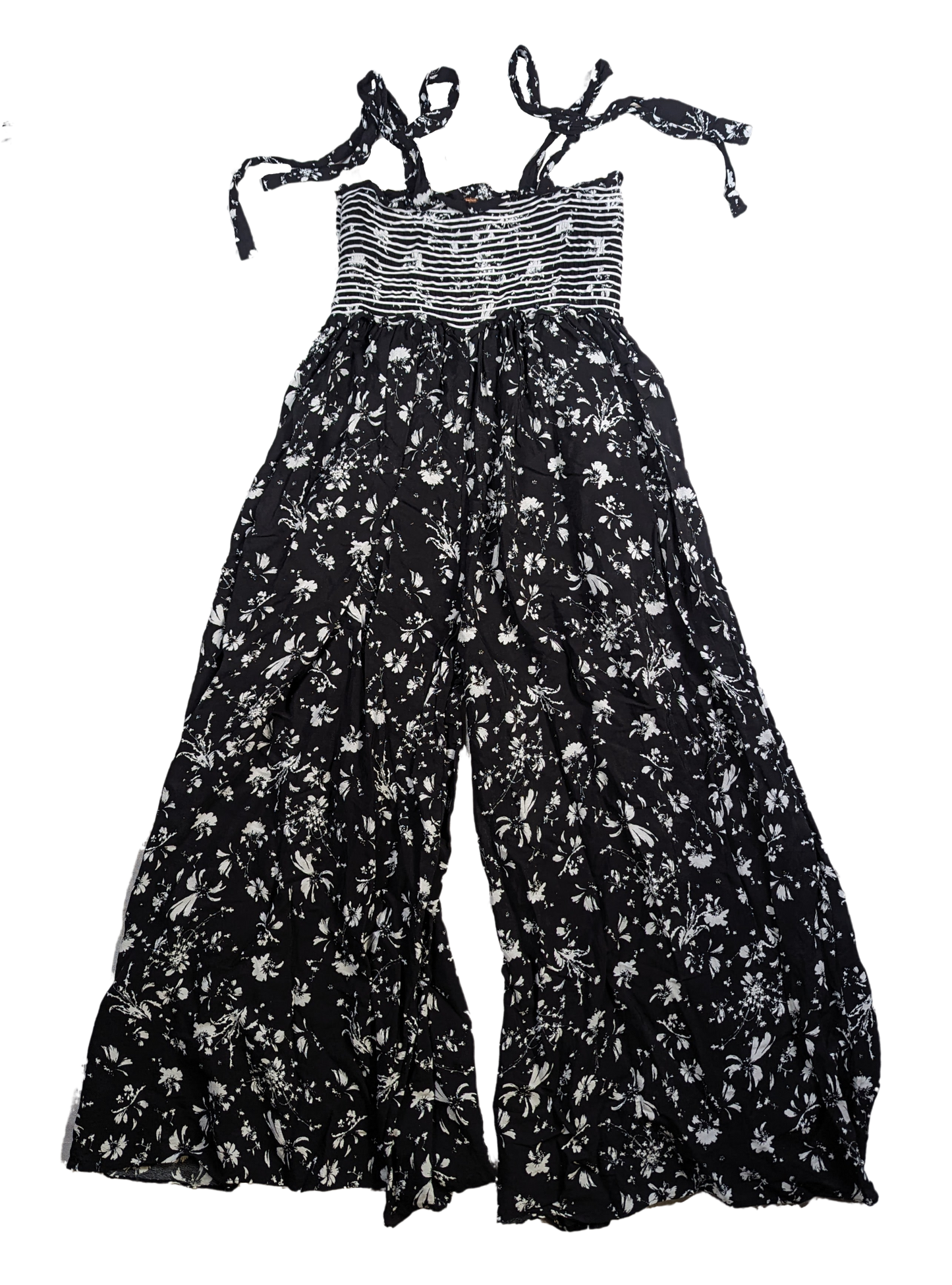Free People Black and White Smocked Jumpsuit Size XS Go bold and free with the Free People Jumpsuit! This black and white stunner features adjustable shoulder ties a