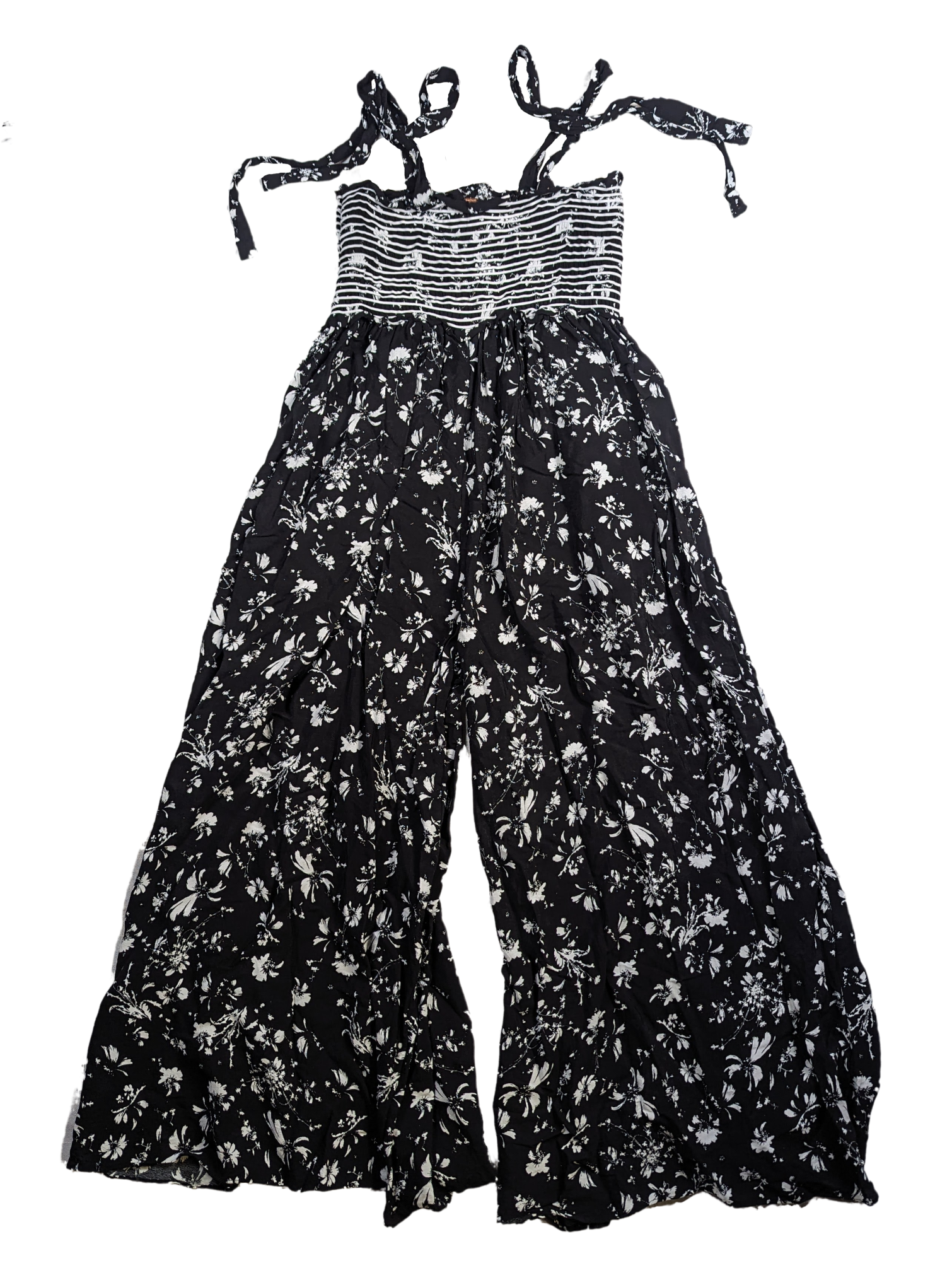 Free People Black and White Smocked Jumpsuit Size XS Go bold and free with the Free People Jumpsuit! This black and white stunner features adjustable shoulder ties a