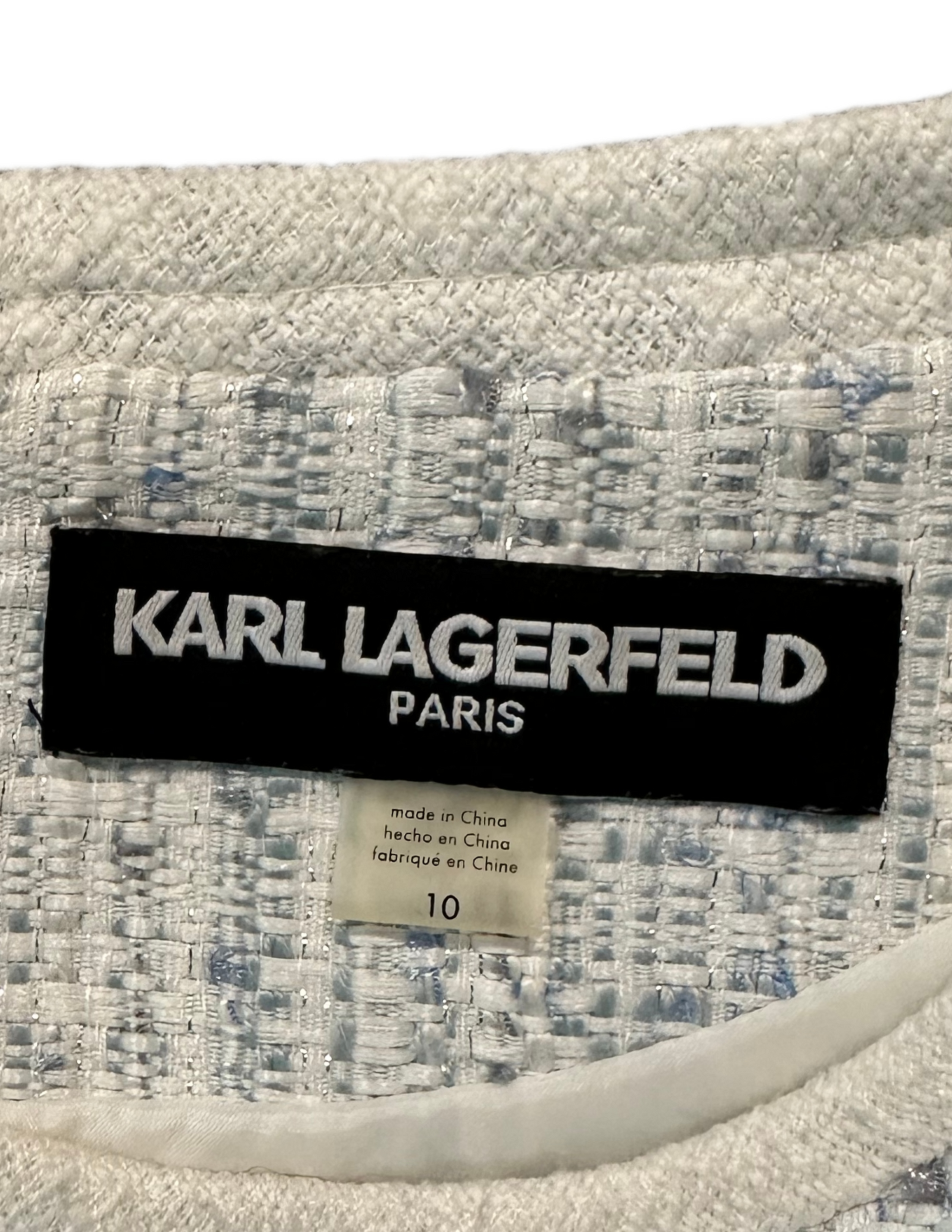 Karl Lagerfeld Paris Jacquard Metallic Light Blue Tweed Sleeveless Dre This Karl Lagerfeld Paris dress is an elegant addition to any wardrobe. The criss cross waist 