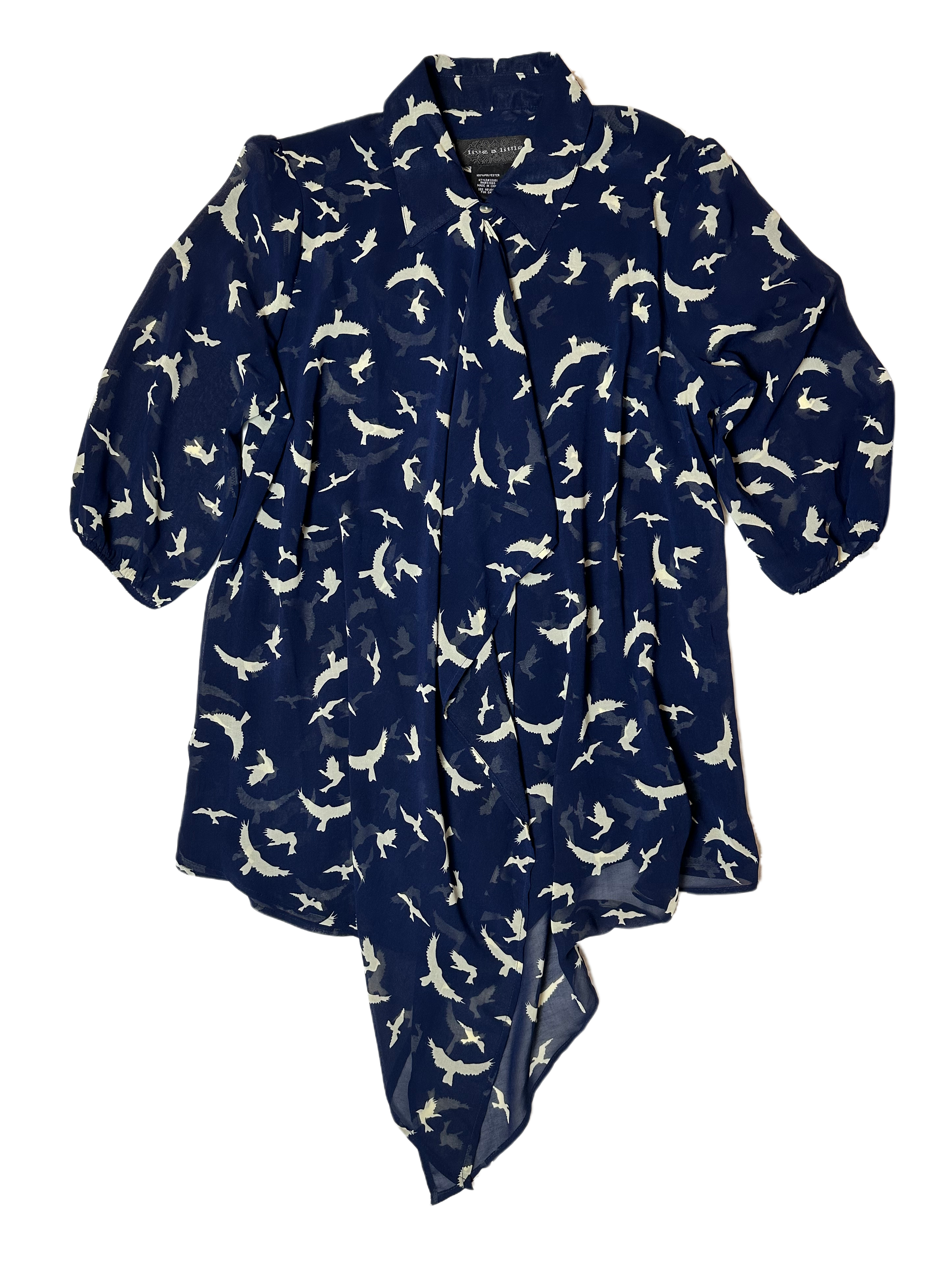 Live a Little Bird Print Blouse with Flowy Front is both stylish and fun. Featuring a unique bird pattern, slightly puffy sleeves, and a flowy front with button closure, this daShirtLive a Little Bird Print Blouse with Flowy FrontBird Print Blouse
