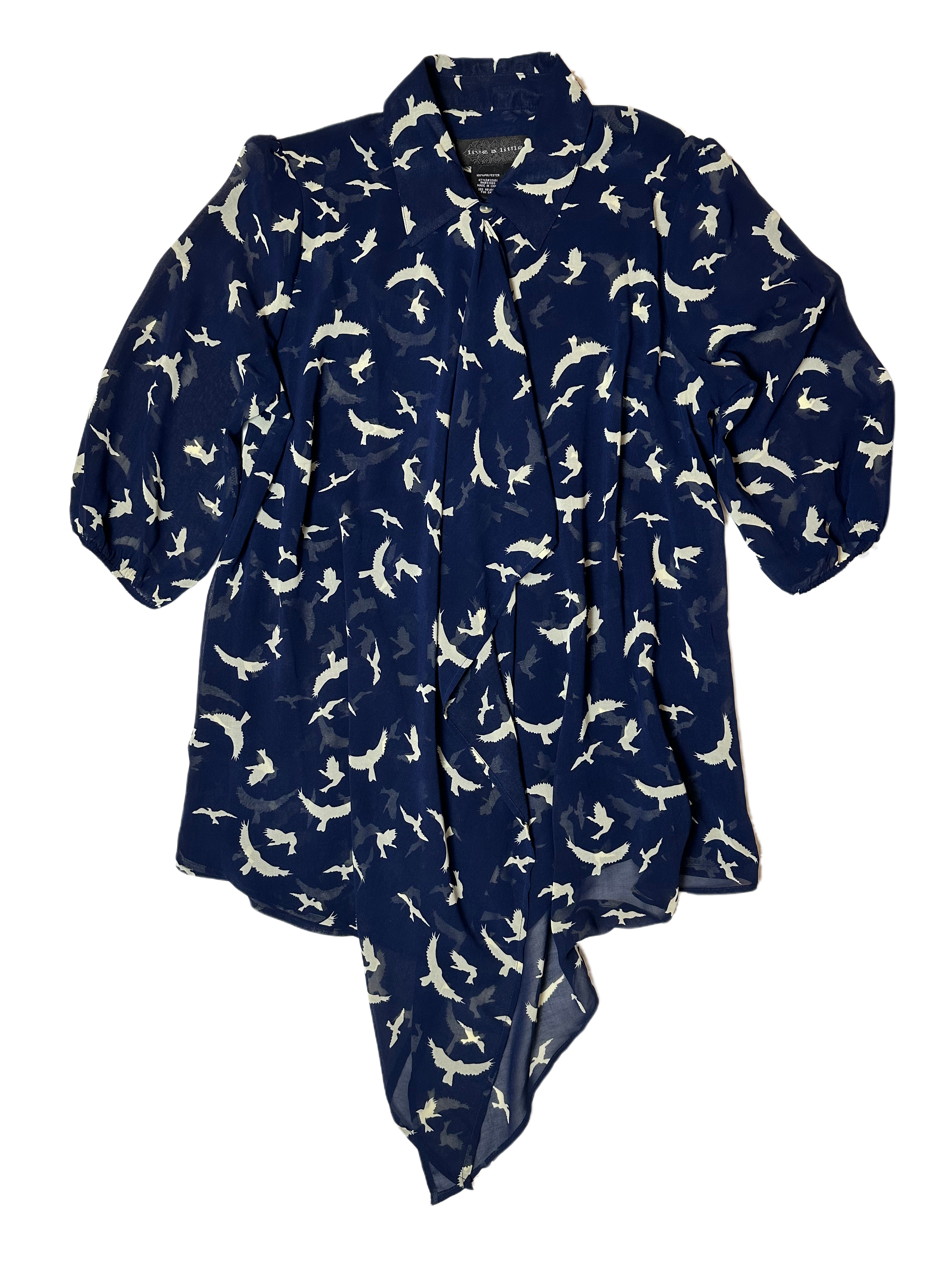 Live a Little Bird Print Blouse with Flowy Front is both stylish and fun. Featuring a unique bird pattern, slightly puffy sleeves, and a flowy front with button closure, this daShirtLive a Little Bird Print Blouse with Flowy FrontBird Print Blouse