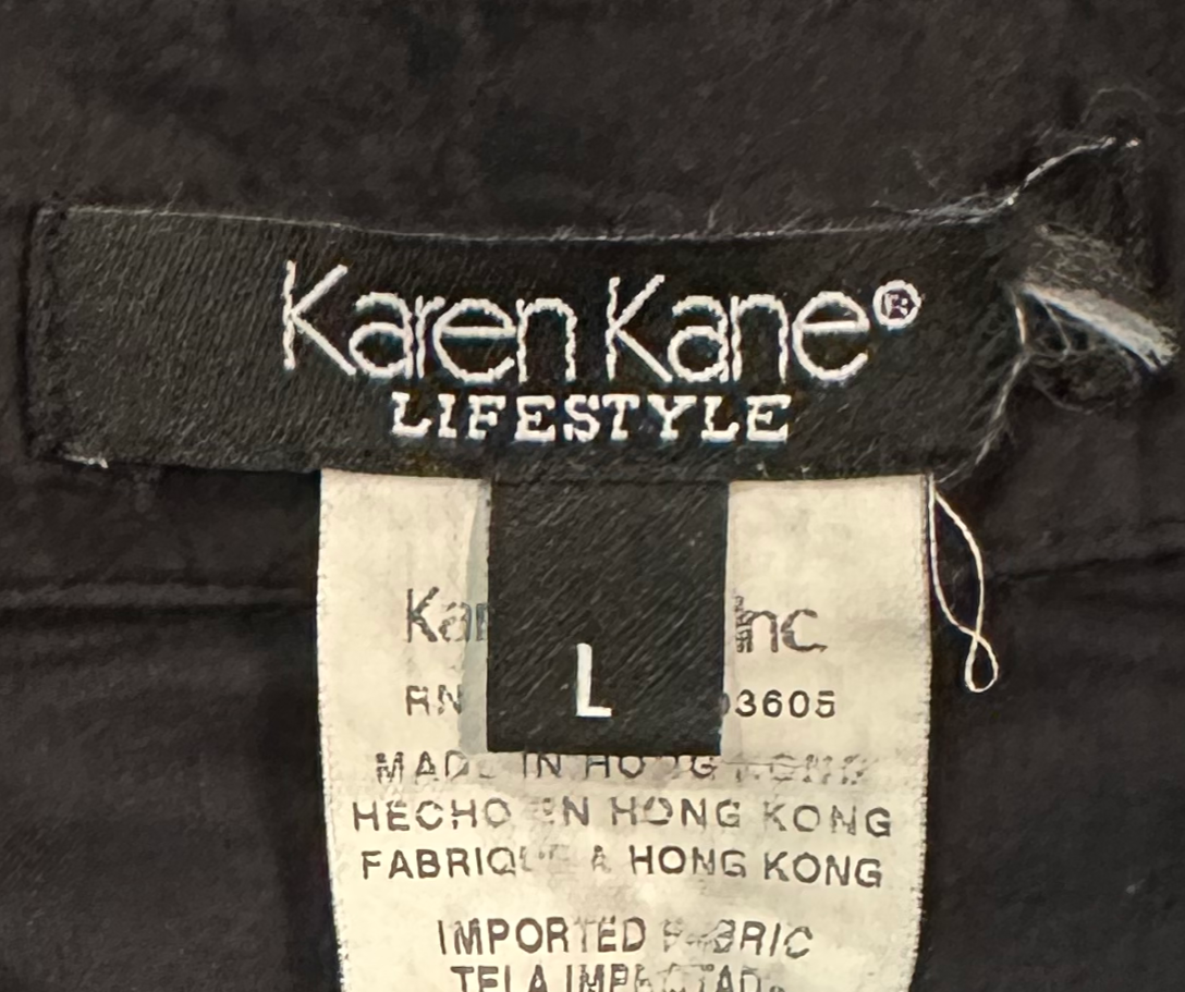 Karen KaneEnhance your wardrobe with this timelessly chic Karen Kane blouse. Delicately crafted from 100% cotton, its split collar and cuffs lend a relaxed elegance, while theBlouseKaren Kane Black Semi Sheer Boho Blouse with Embroidery DetailsKaren Kane Black Semi Sheer Boho Blouse