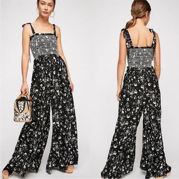 Free People Black and White Smocked Jumpsuit Size XS Go bold and free with the Free People Jumpsuit! This black and white stunner features adjustable shoulder ties a