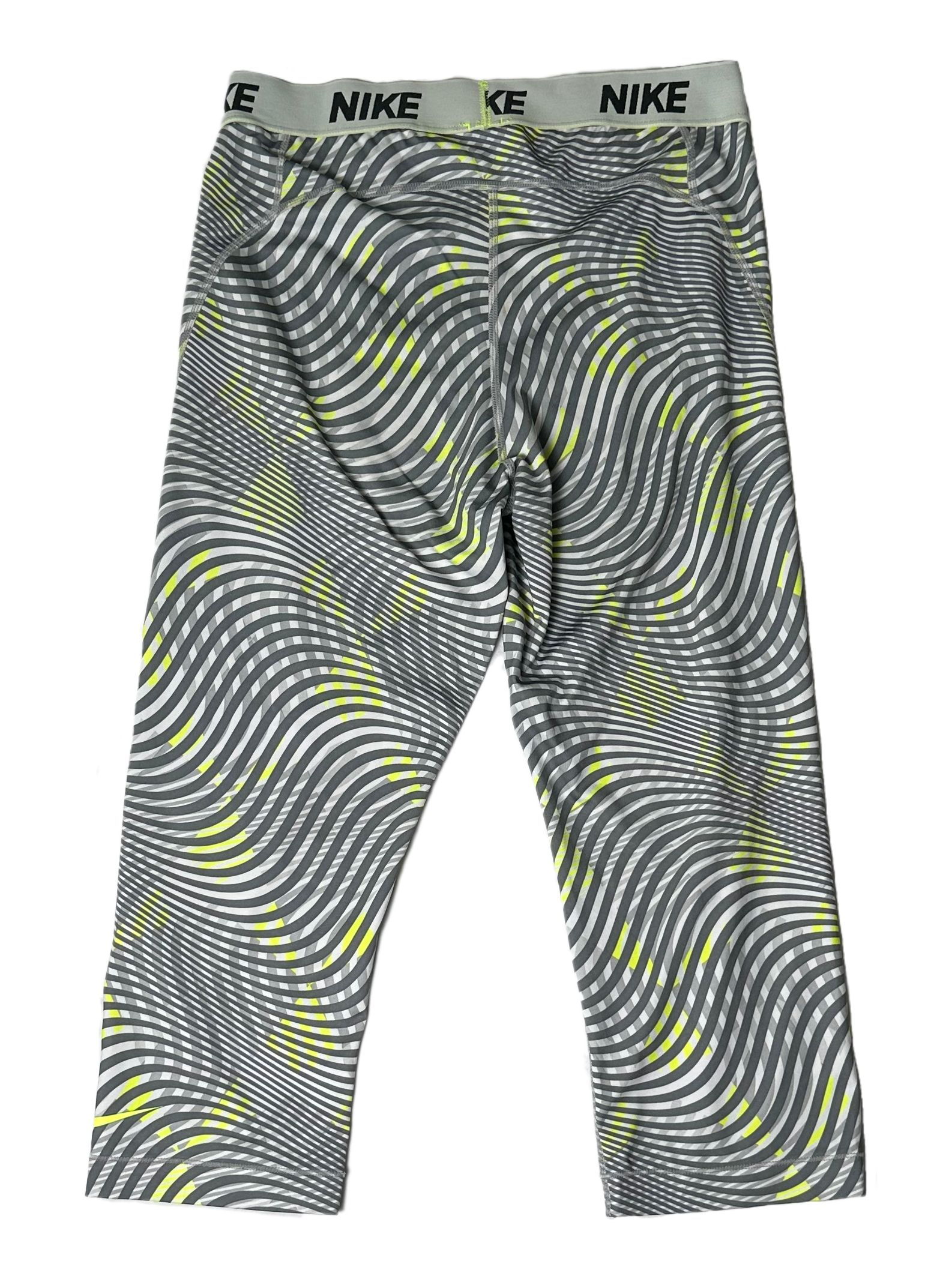 NikeTear through your workout with these Nike Dri Fit cropped leggings! Made with a sleek grey and lime green swirl print, these moisture-wicking leggings will make sureLeggingsNike Dri Fit Cropped Grey Print LeggingsNike Dri Fit Cropped Grey Print Leggings