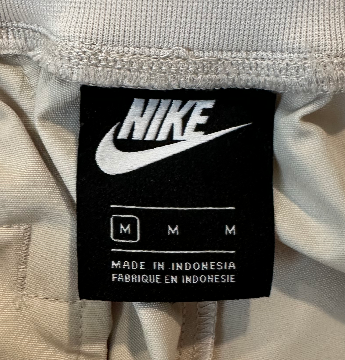 Nike Women's Nude Zip Front Cargo Joggers  Patent Leather Details sze M Effortless style meets functional cool with these cargo joggers that refuse to take themselv