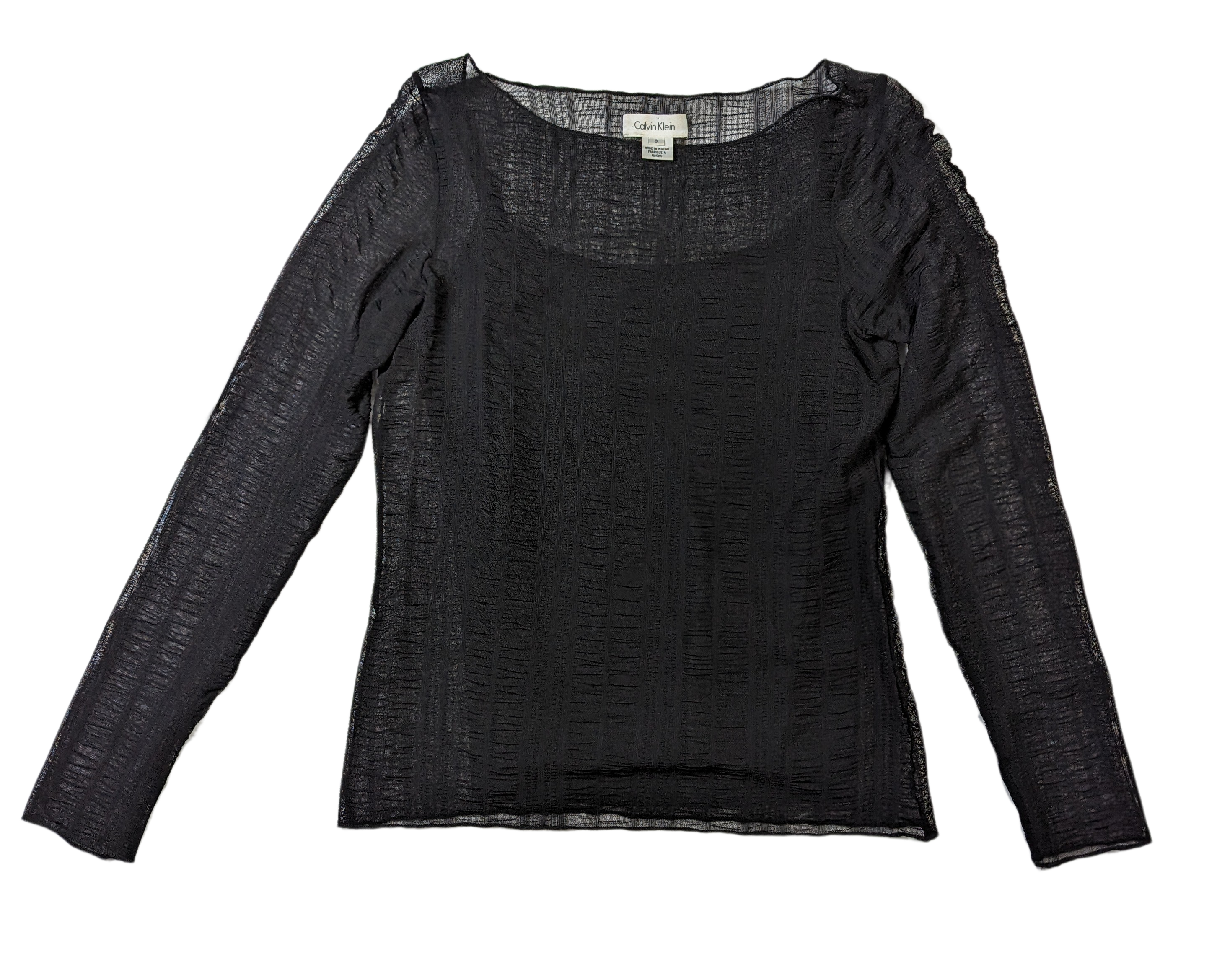 Calvin Klein Long Sleeve Sheer Top Calvin Klein's Long Sleeve Sheer Top offers a sleek, timeless option for any wardrobe. Crafted with a subtle ruching effect in the sheer layer and an attached tank l