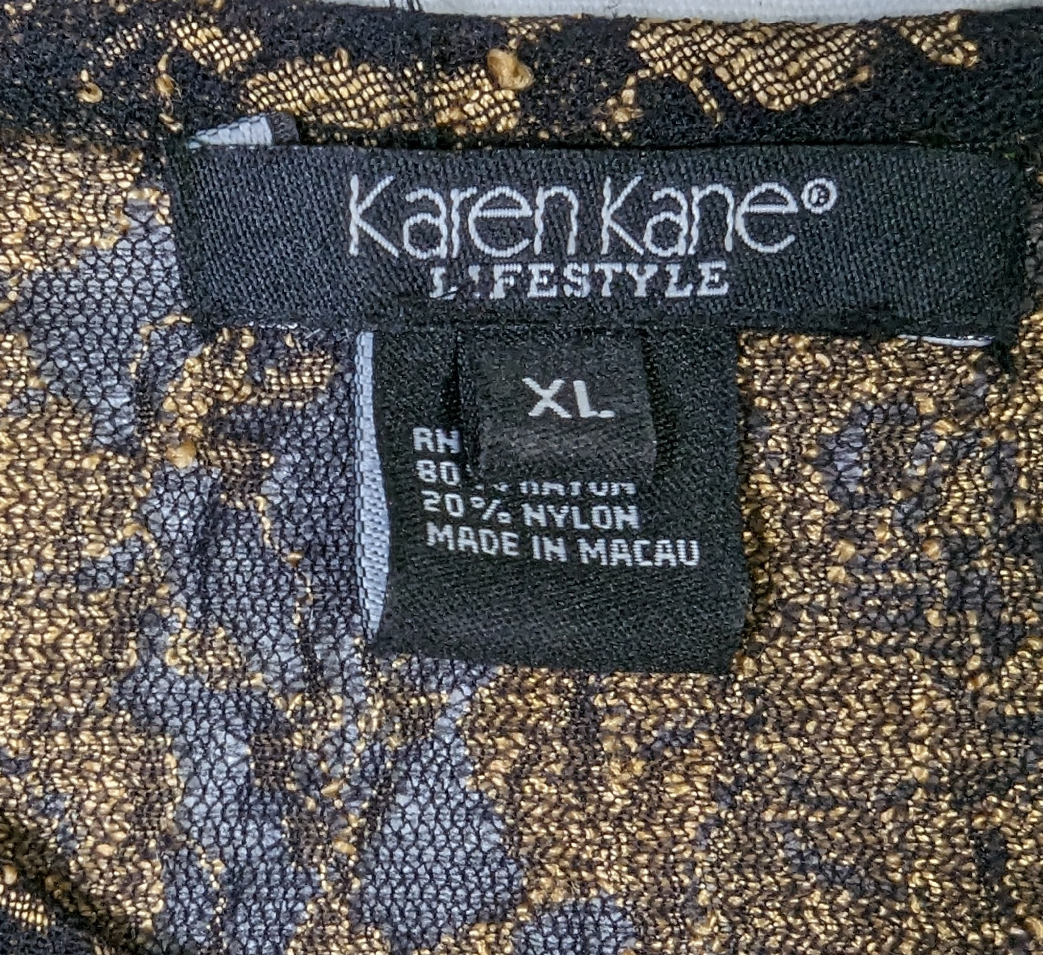 Karen Kane Black and Gold Beaded TopThis Karen Kane top is a stylish and sophisticated choice for any wardrobe. Its intricate black and gold lace design is paired with a luxuriously soft feel that make