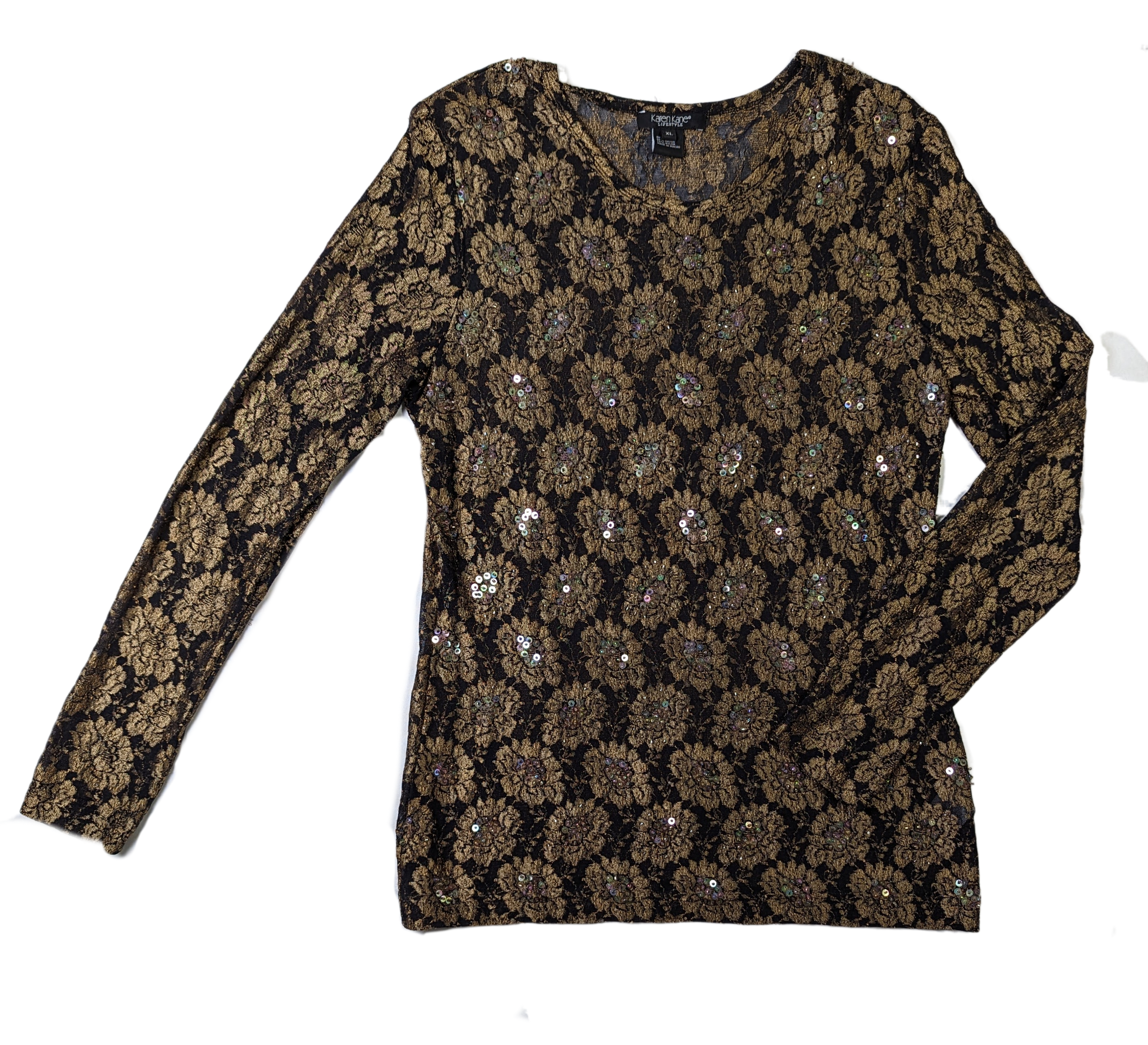 Karen Kane Black and Gold Beaded TopThis Karen Kane top is a stylish and sophisticated choice for any wardrobe. Its intricate black and gold lace design is paired with a luxuriously soft feel that make