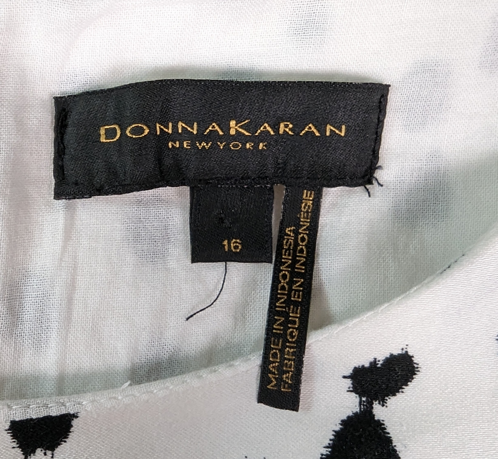 Donna Karan Sleeveless Black and White Dress with Polka Dots and Asymmetrical Hem.A painterly Dalmatian dot print patterns this sleeveless dress, with an ombré dot finish and asymmetric hemline adding flair to the silhouette. Round neck,  sleeveleDonna Karan White DressDresses