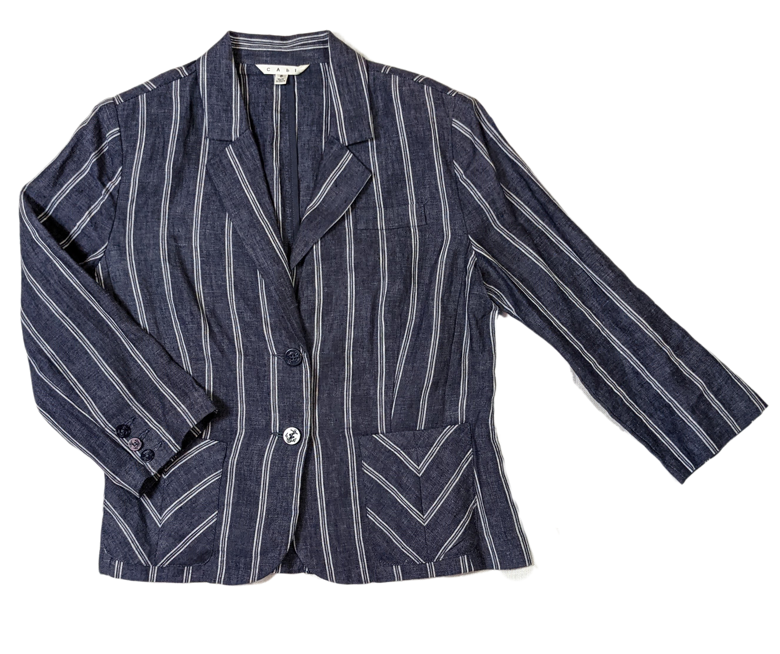 CAbi Linen Pinstripe JacketThis Jacket looks sharp with chevron styled pockets and white pinstripes on the blue linen. The 3/4 sleeves give the blazer a relaxed look.